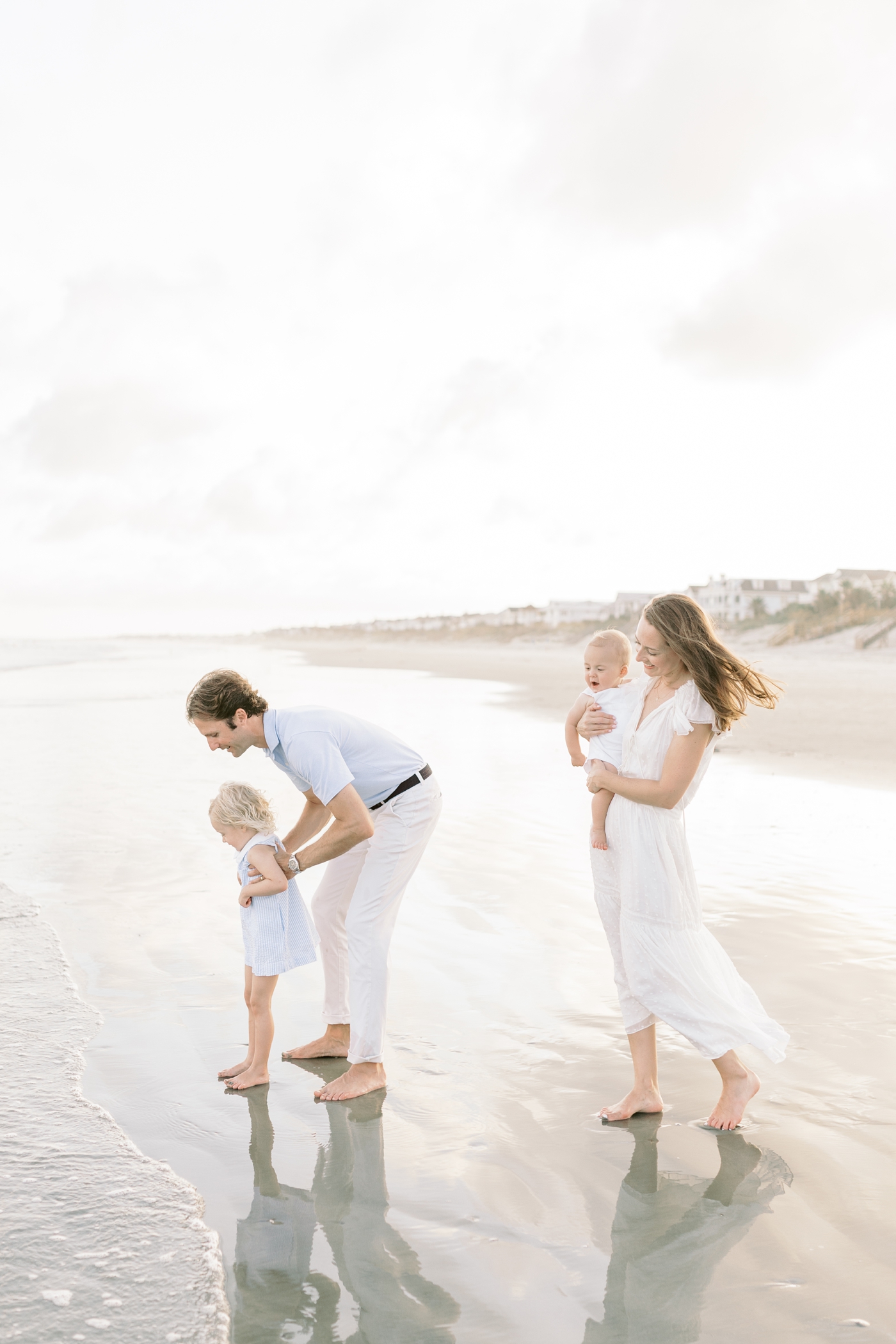 Family playing on the beach | Photo by Caitlyn Motycka Photography.