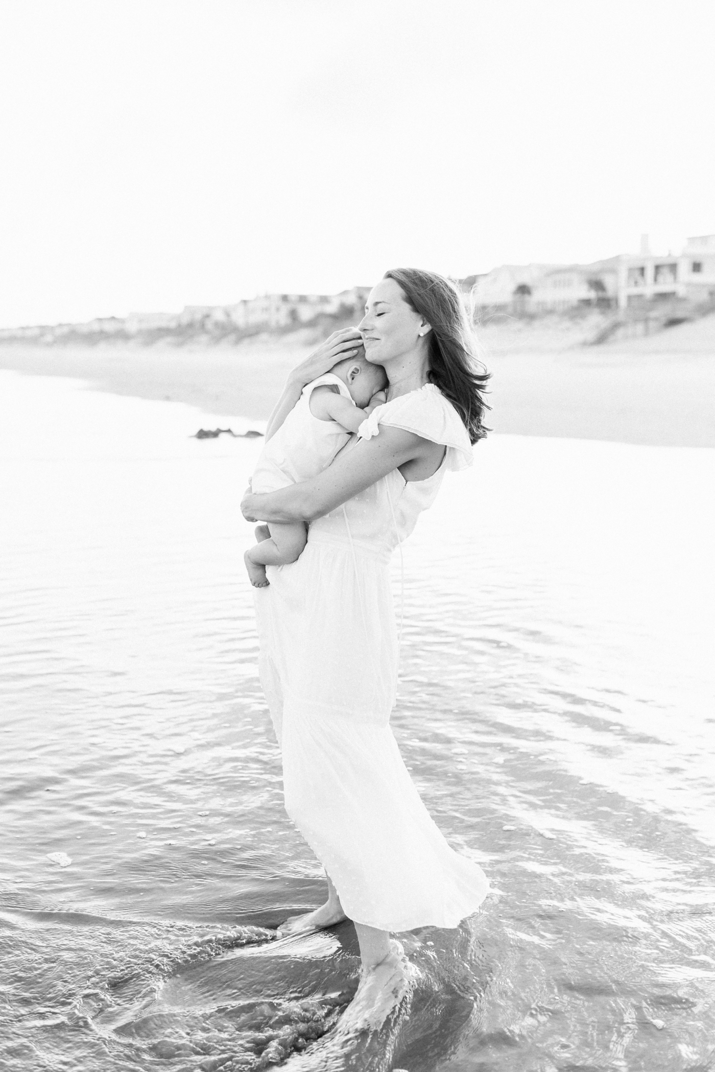 Mom snuggling her baby boy on the beach | Photo by Caitlyn Motycka Photography.