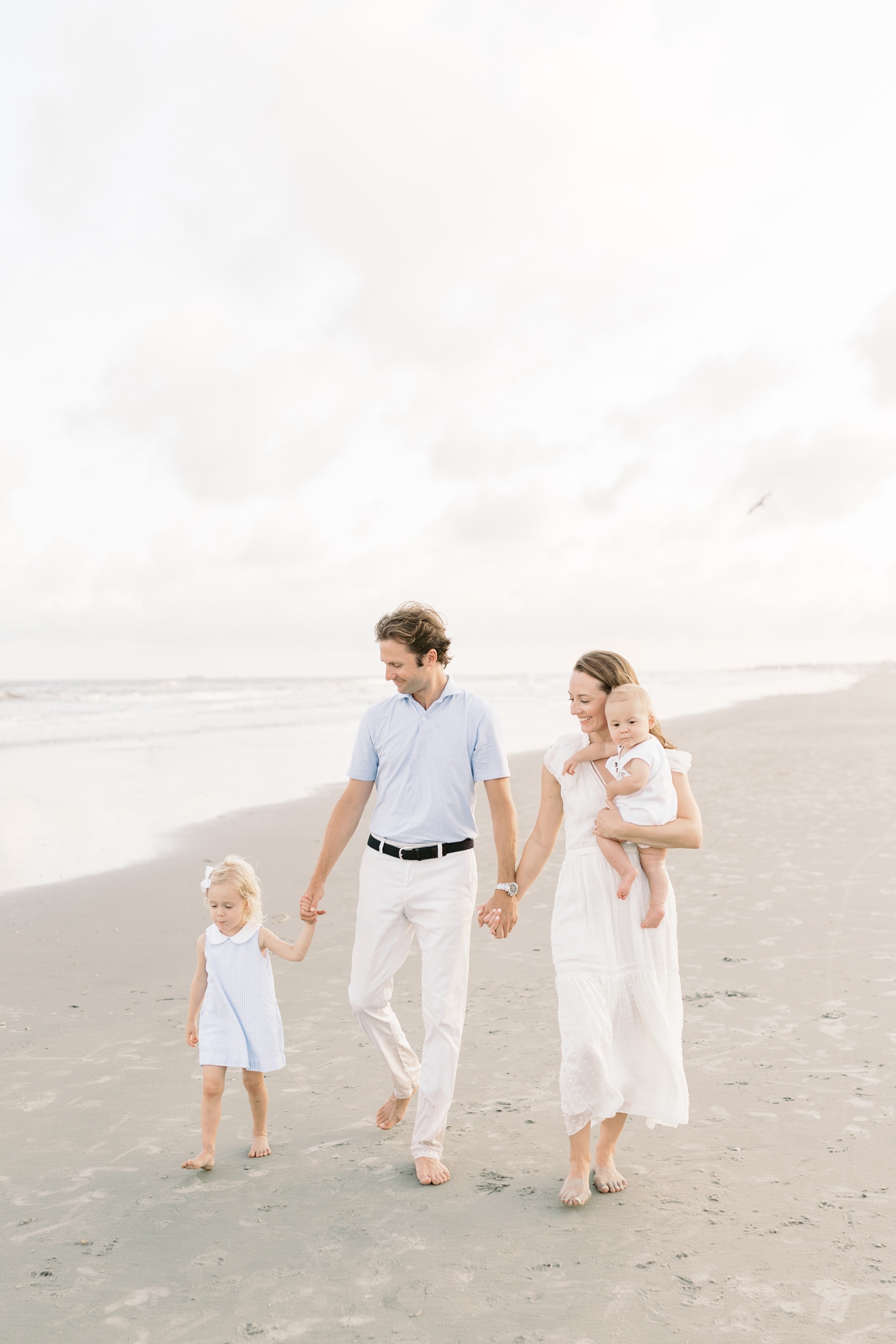 Family walking on the beach during their Isle of Palms Family Session | Photo by Caitlyn Motycka Photography.