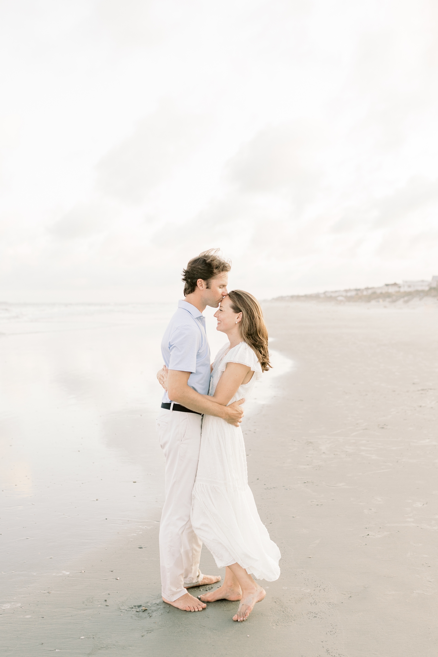 Couple embracing on the beach | Photo by Caitlyn Motycka Photography.