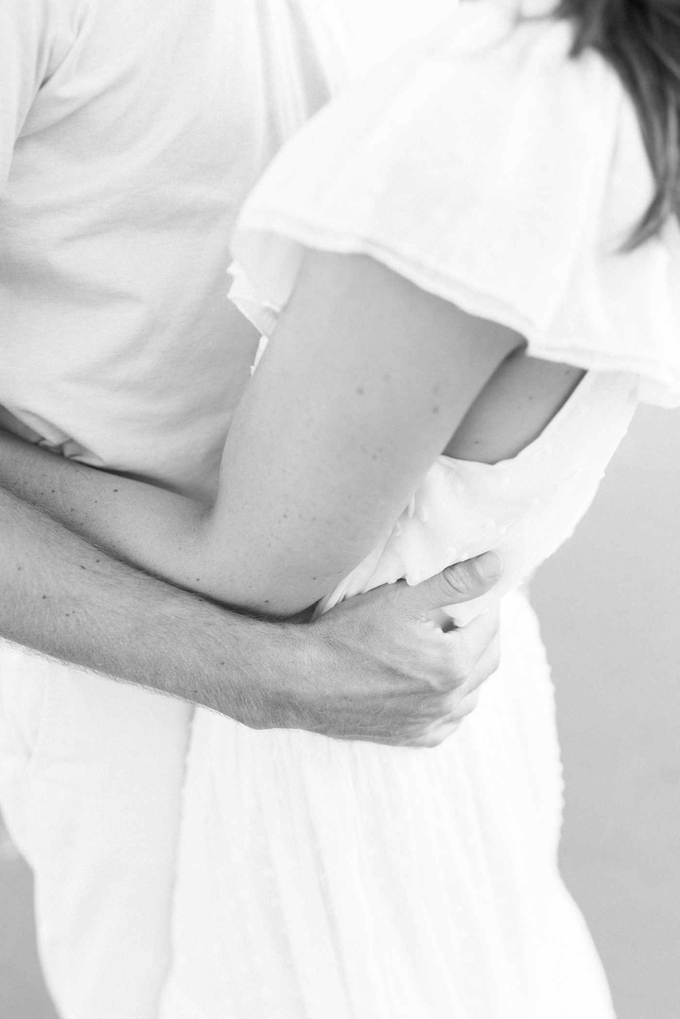 Black and white photo of couple embracing | Photo by Caitlyn Motycka Photography.