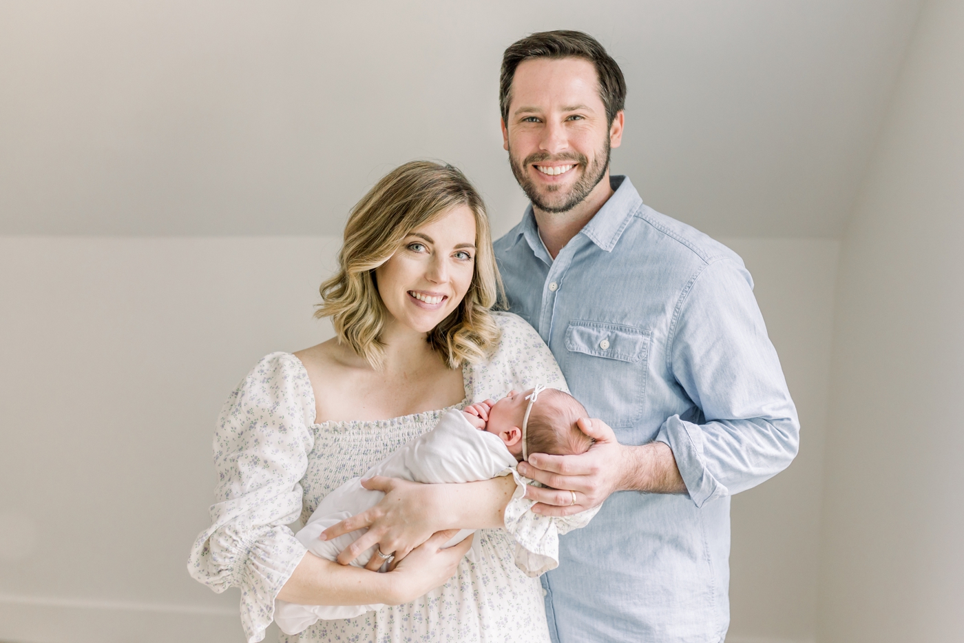 Mom, dad, and baby during newborn photos in Mount Pleasant | Photo by Caitlyn Motycka Photography.
