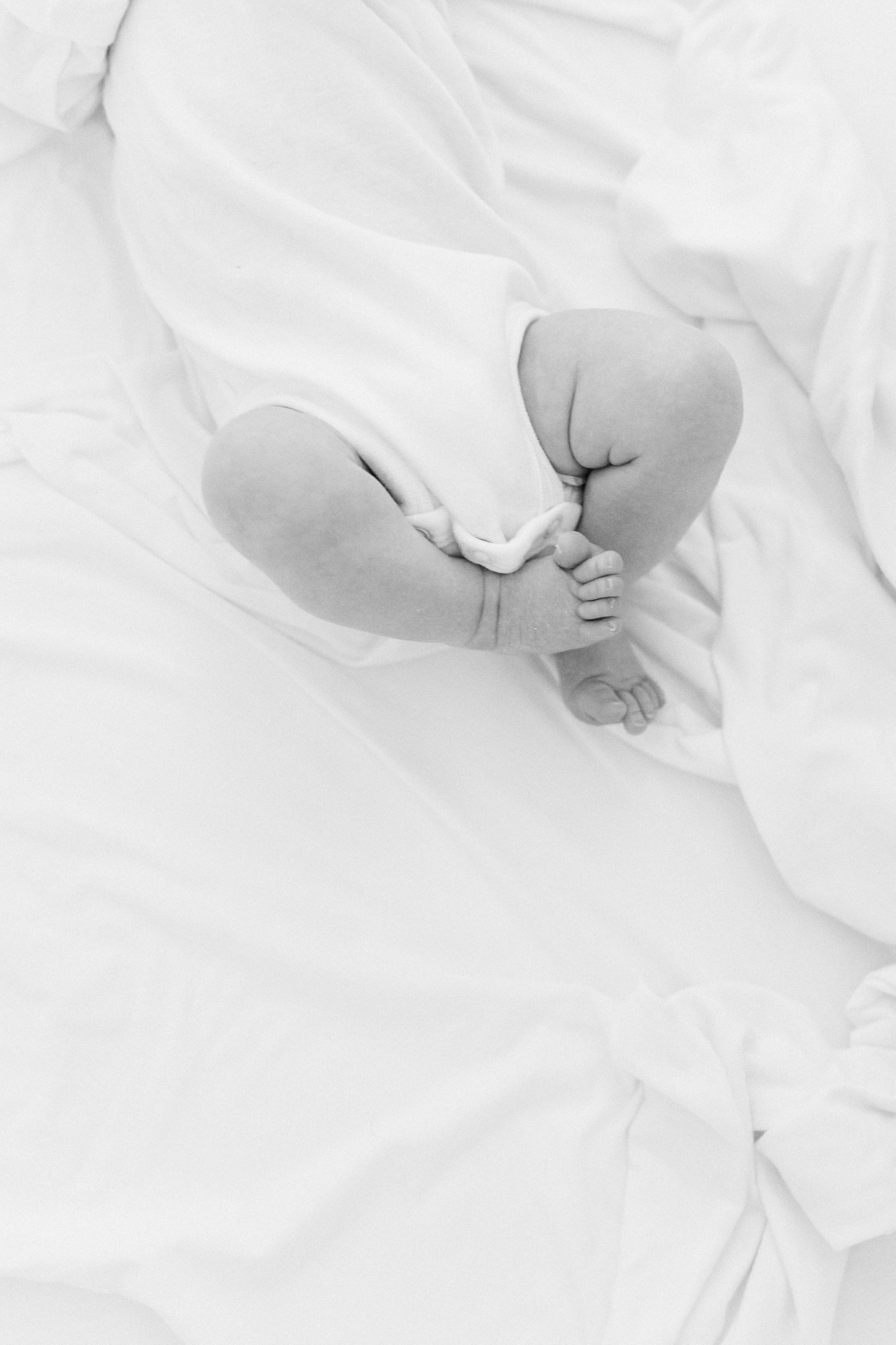 Tiny newborn baby feet | Photo by Caitlyn Motycka Photography.