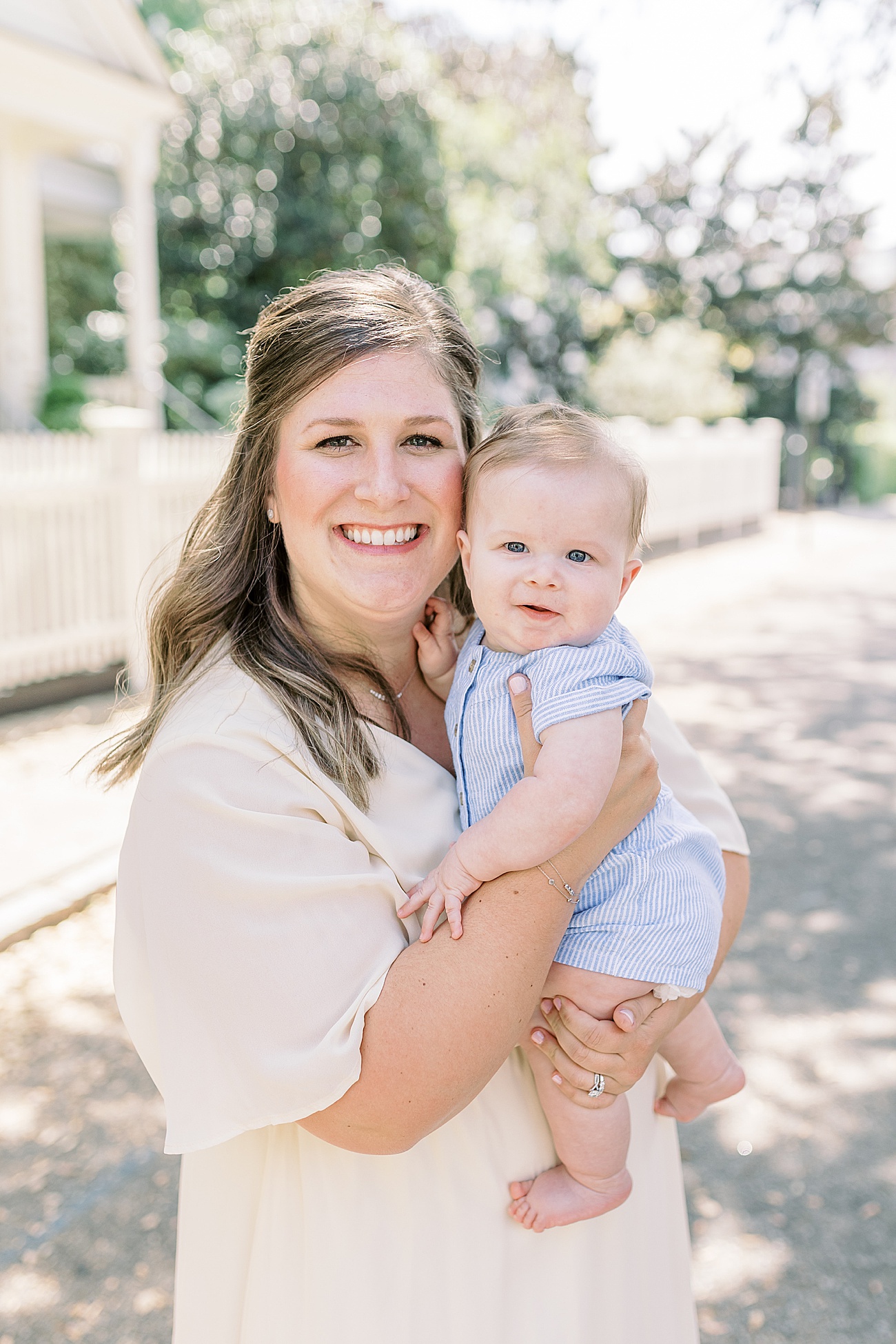 Sweet photo of Mom and baby smiling at camera. Photo by Caitlyn Motycka Photography.