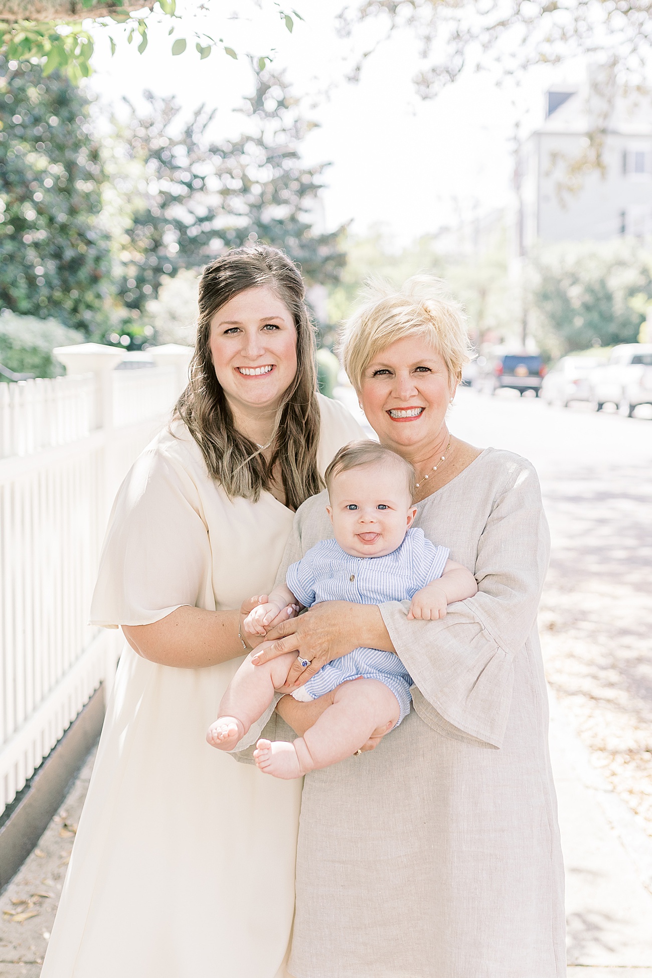 Mom, Grandma and baby smiling at the camera during session in Charleston, SC. Photo by Caitlyn Motycka Photography.