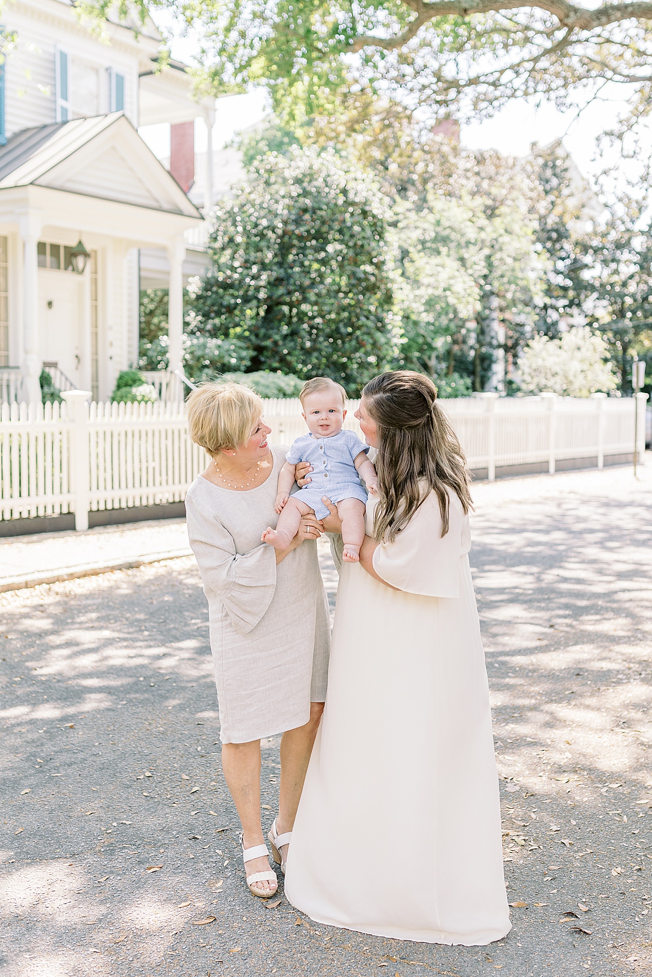 Sweet photo with Mom, baby, and Grandma in downtown Charleston during motherhood mini session event. Photo by Caitlyn Motycka Photography.
