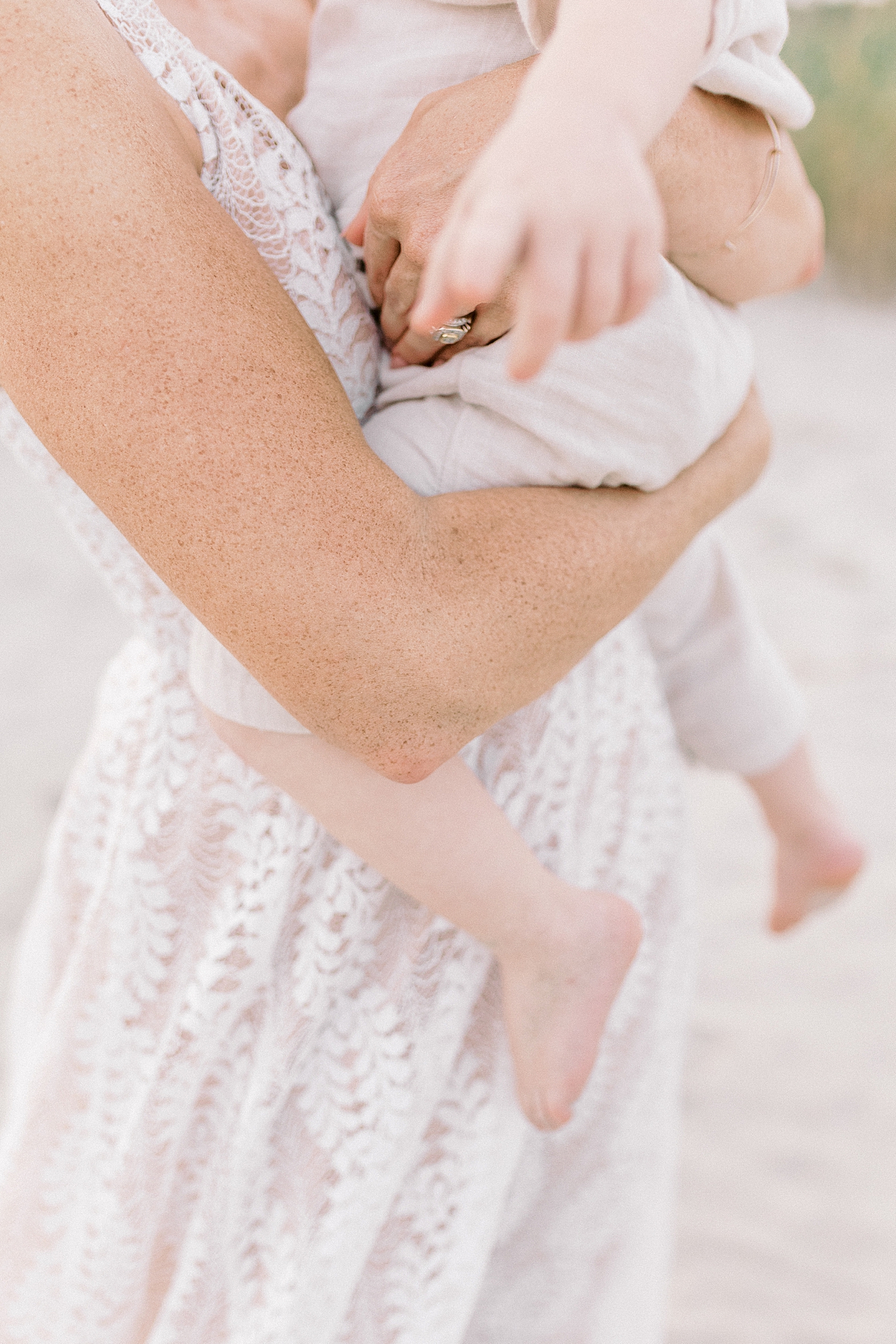 Detail of mom's hands holding her baby boy | Photo by Caitlyn Motycka Photography