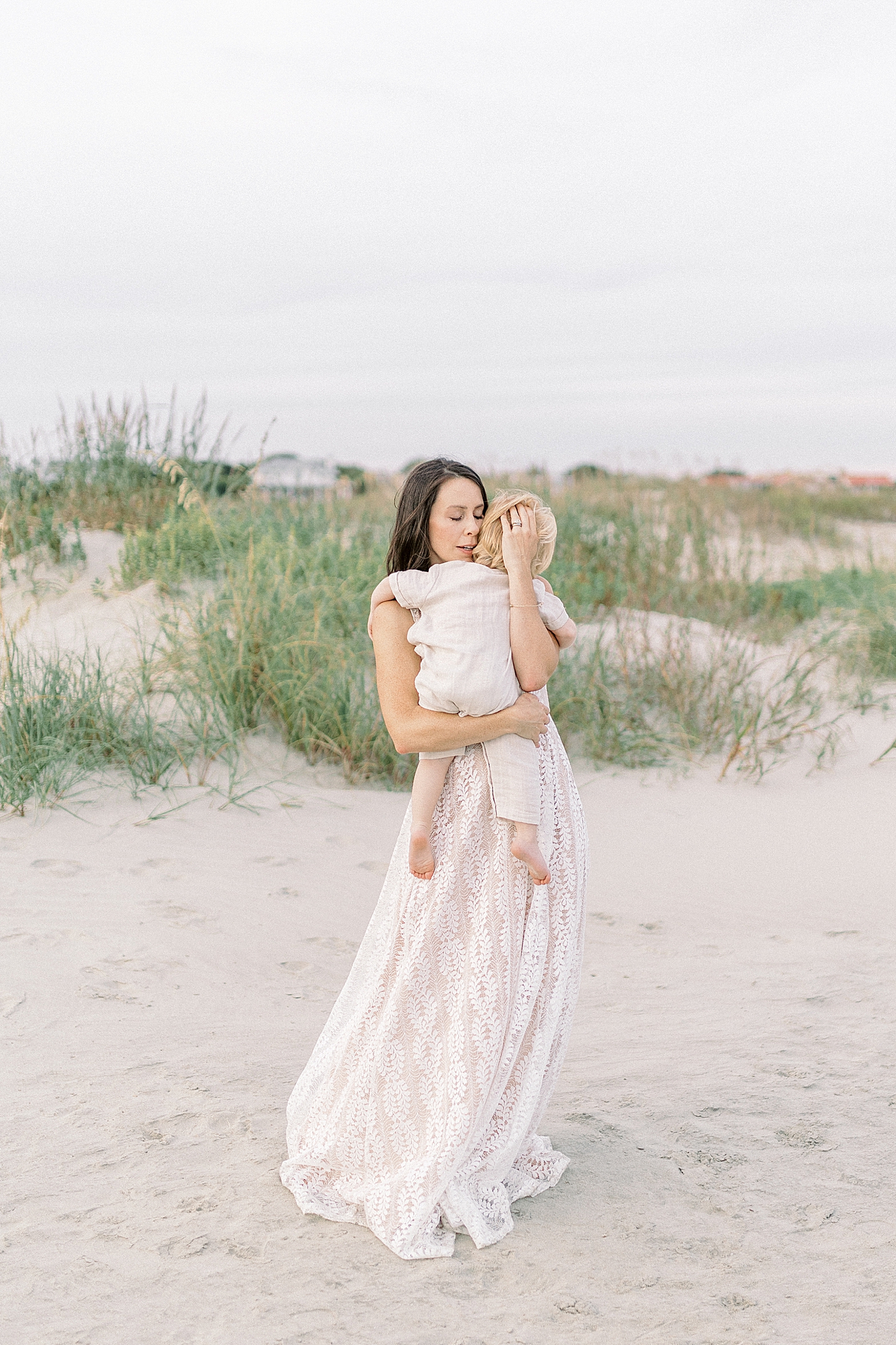 Mom holding her baby boy on the beach | Photo by Caitlyn Motycka Photography