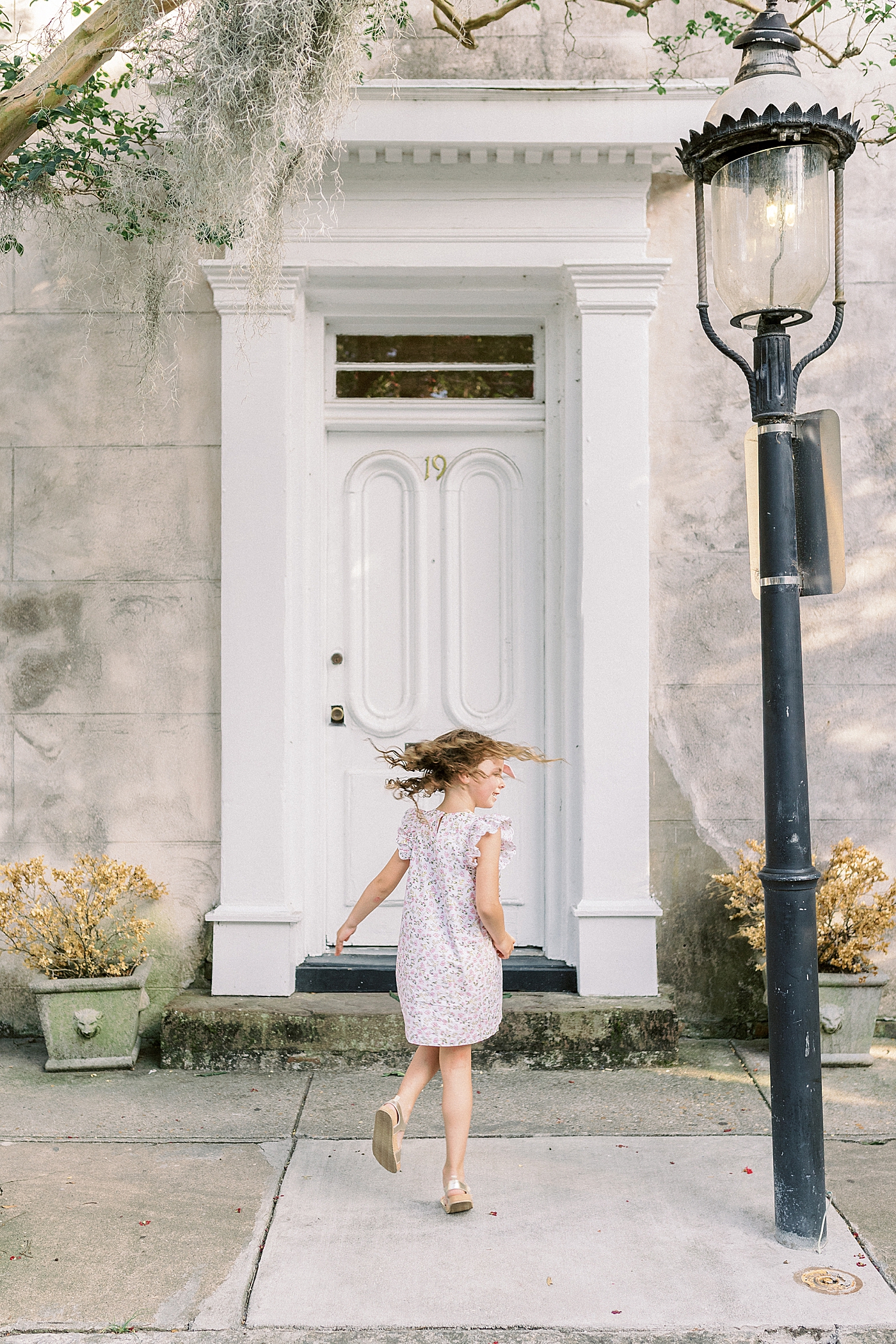 Little girl in a floral dress twirling | Photo by Caitlyn Motycka Photography
