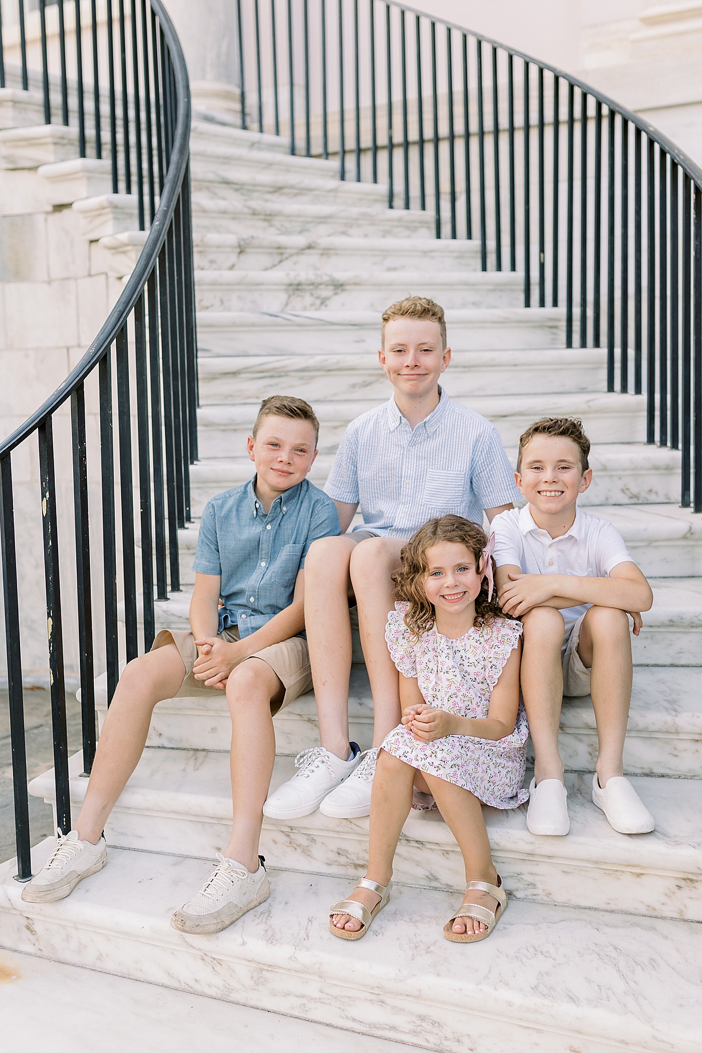 Siblings sitting on a stoop together | Photos by Family Photographer in Downtown Charleston