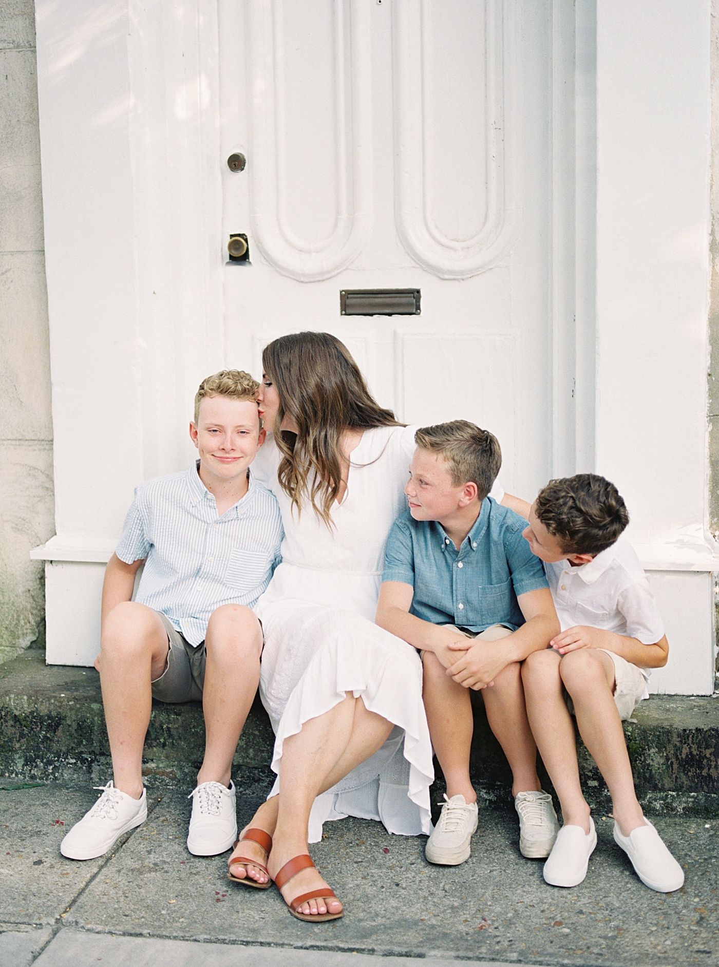 Mom sitting with her boys on a stoop in Charleston | Photo by Caitlyn Motycka Photography