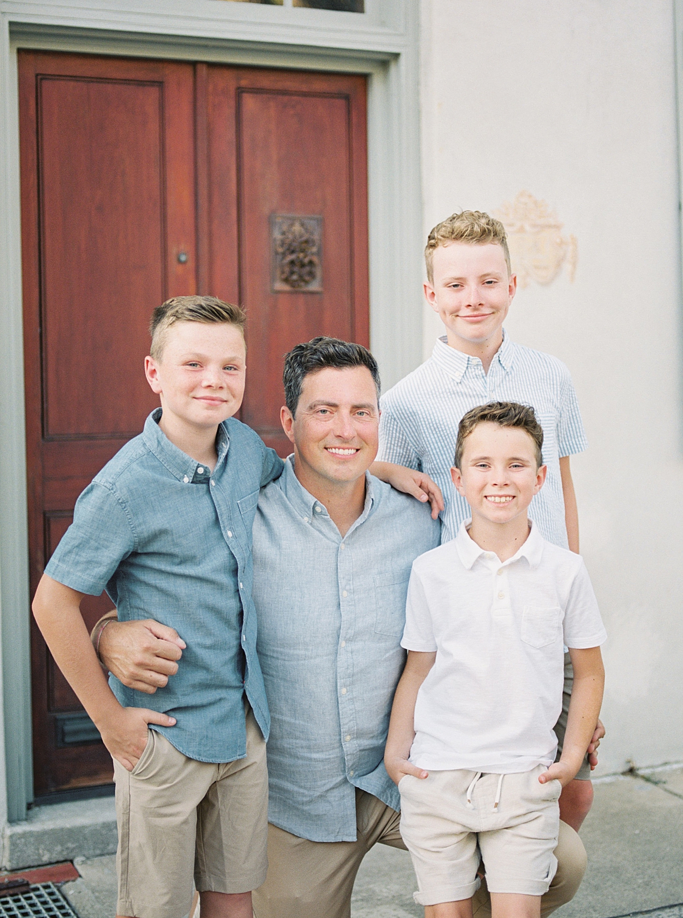 Dad with his three boys smiling | Photos by Family Photographer in Downtown Charleston