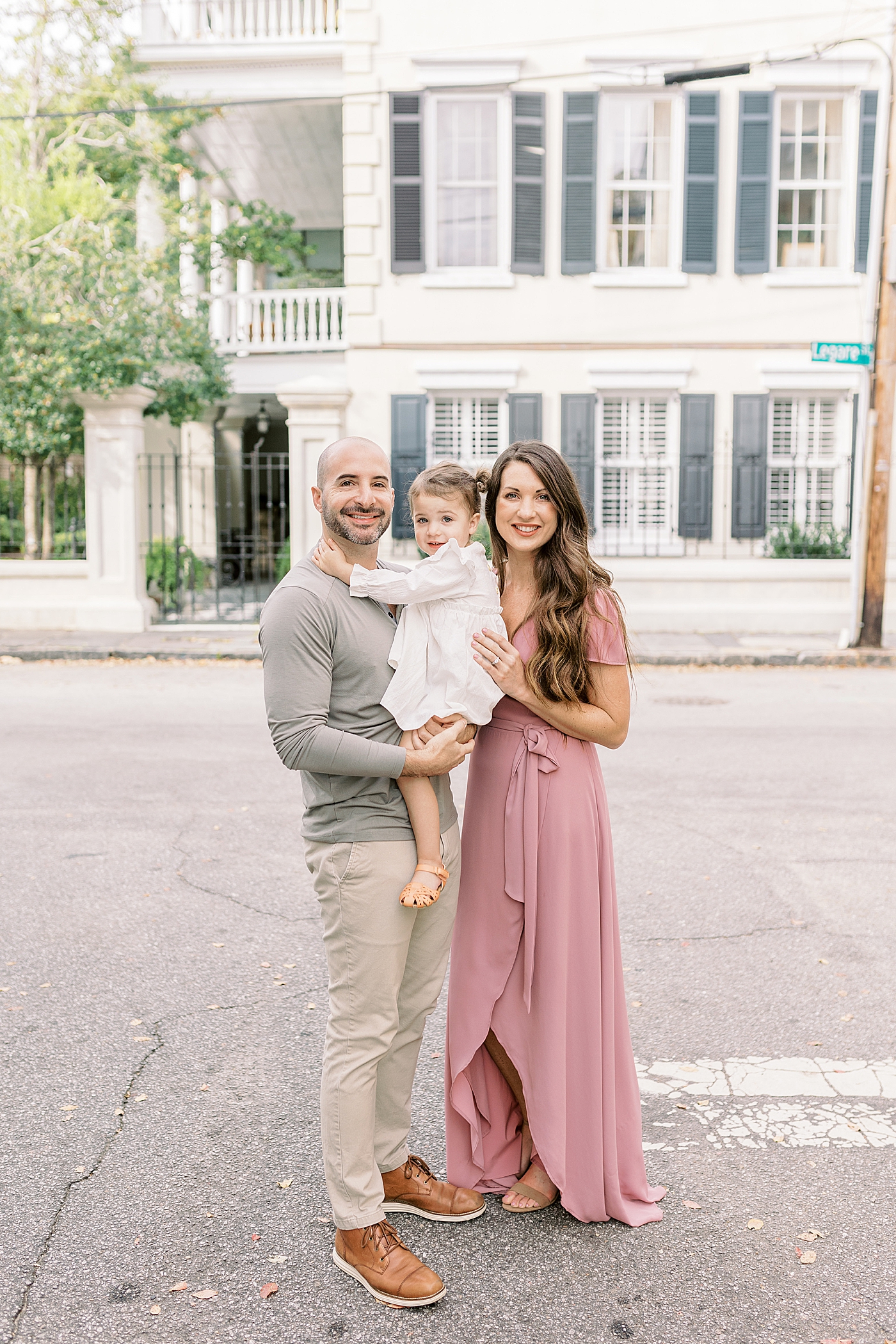 Family of three in downtown Charleston | Photo by Caitlyn Motycka Photography