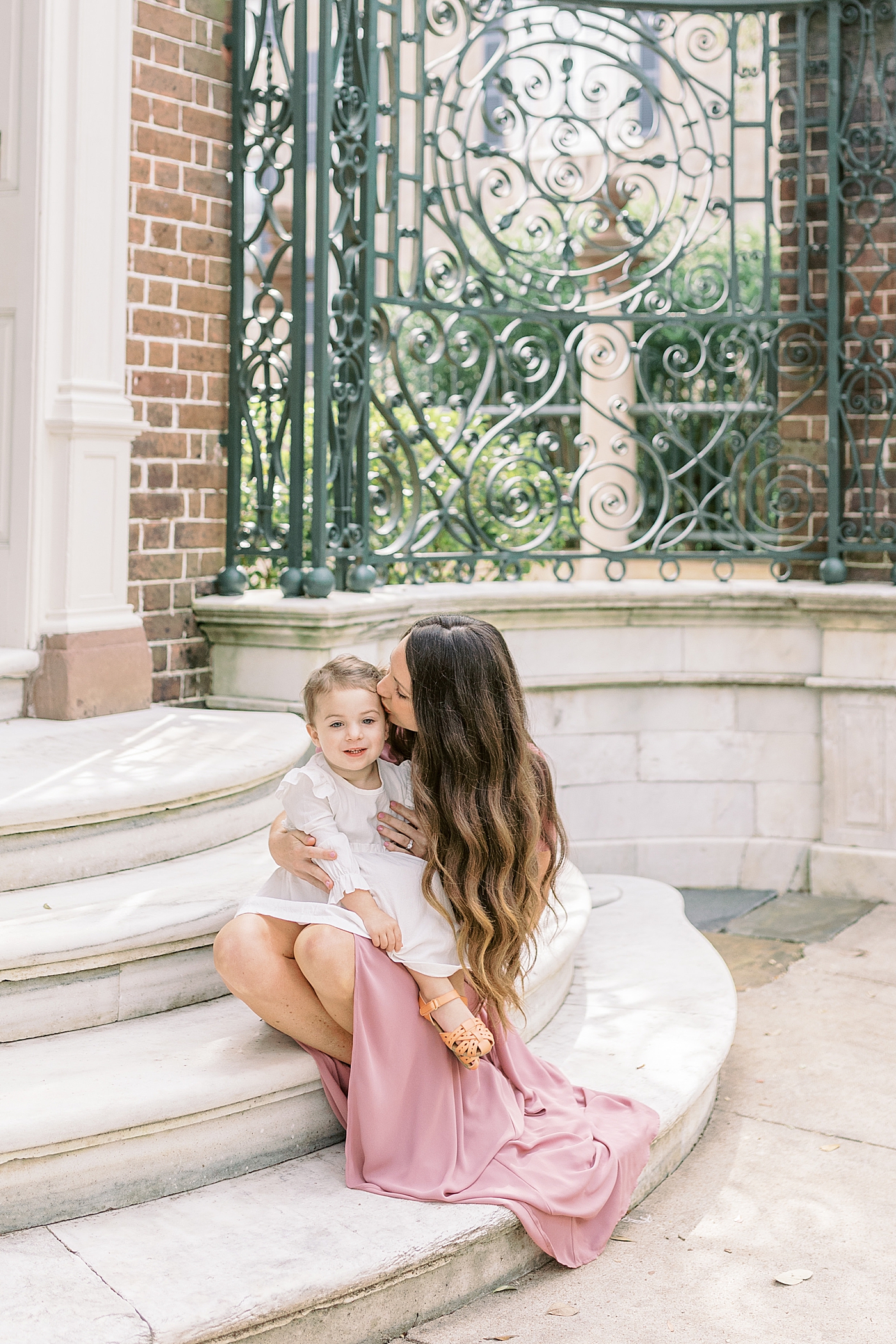Mom and daughter sitting on a stoop during their Fall Family Mini Session | Photo by Caitlyn Motycka Photography