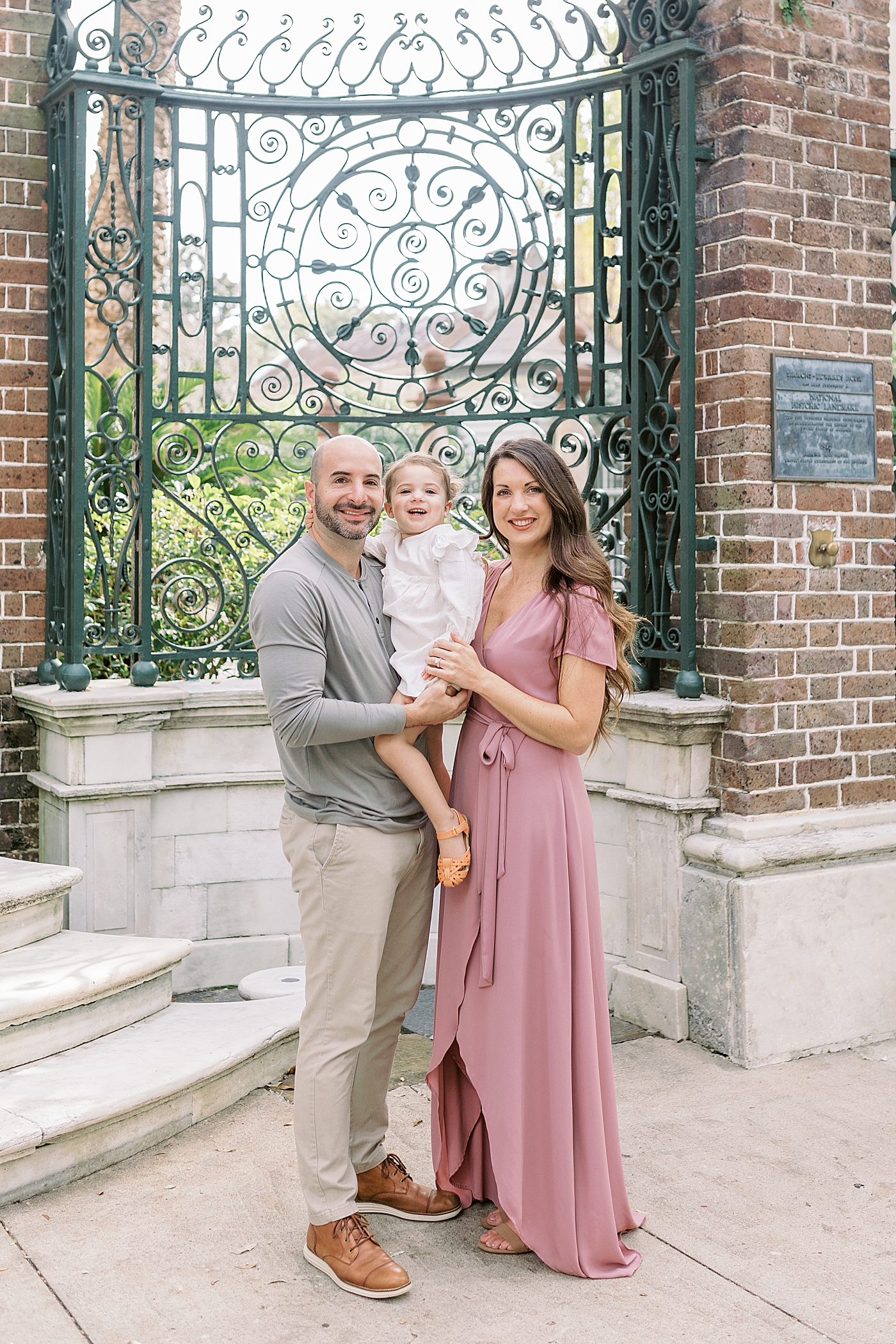 Mom and dad with their toddler girl posing | Photo by Caitlyn Motycka Photography