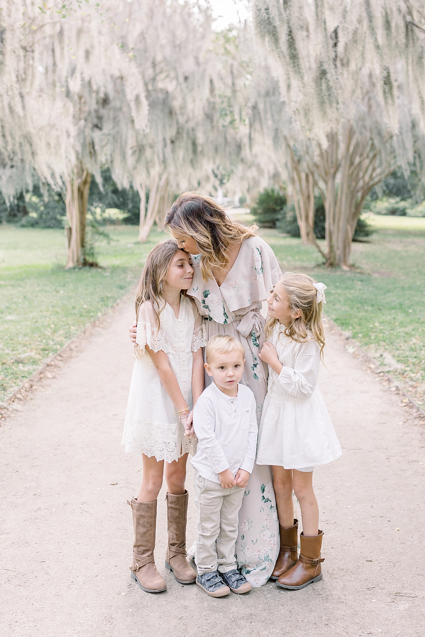 Mom snuggling with her kids during their Fall Family Photos in Charleston | Photo by Caitlyn Motycka Photography