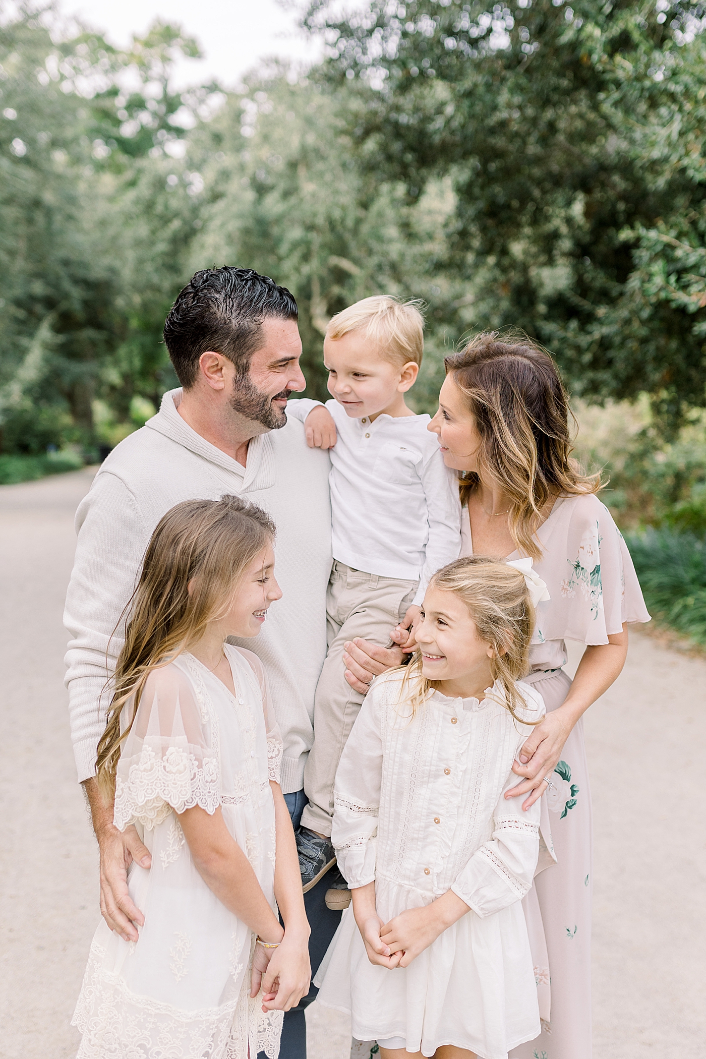 Mom and dad hugging their three kids during their Fall Family Photos in Charleston | Photo by Caitlyn Motycka Photography