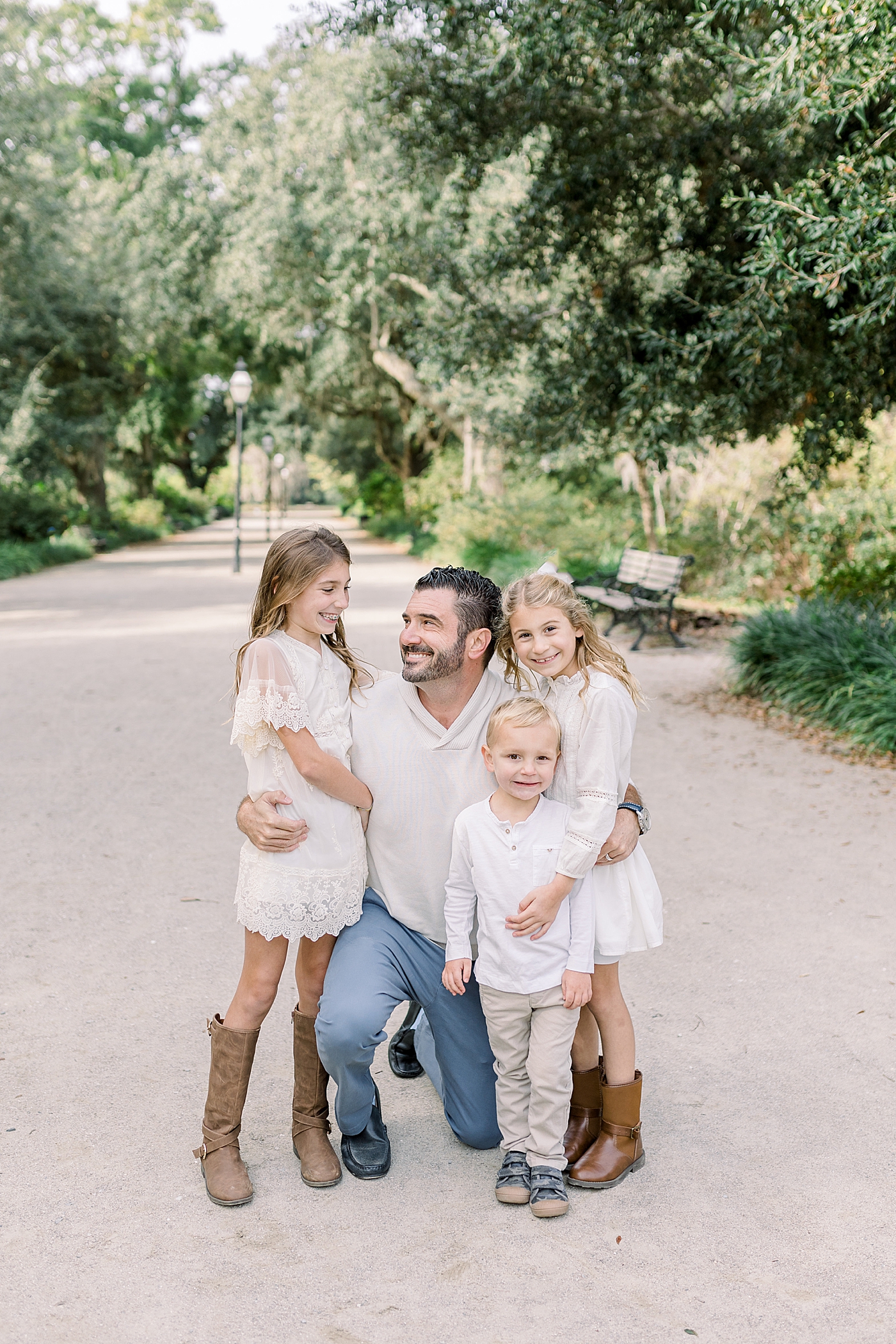 Dad snuggling with his three kids during their Fall Family Photos in Charleston | Photo by Caitlyn Motycka Photography