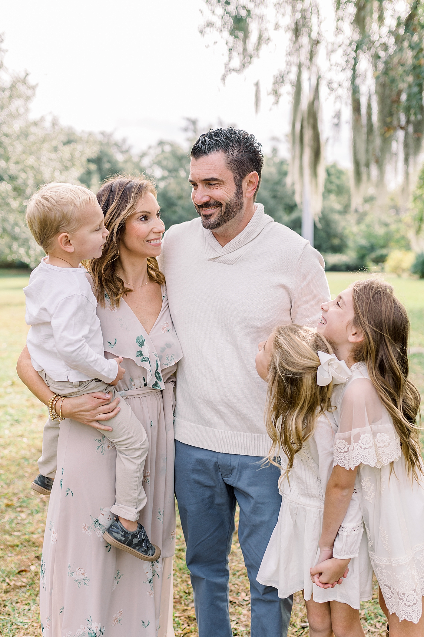 Mom and dad snuggling with their kids during their Fall Family Photos in Charleston | Photo by Caitlyn Motycka Photography