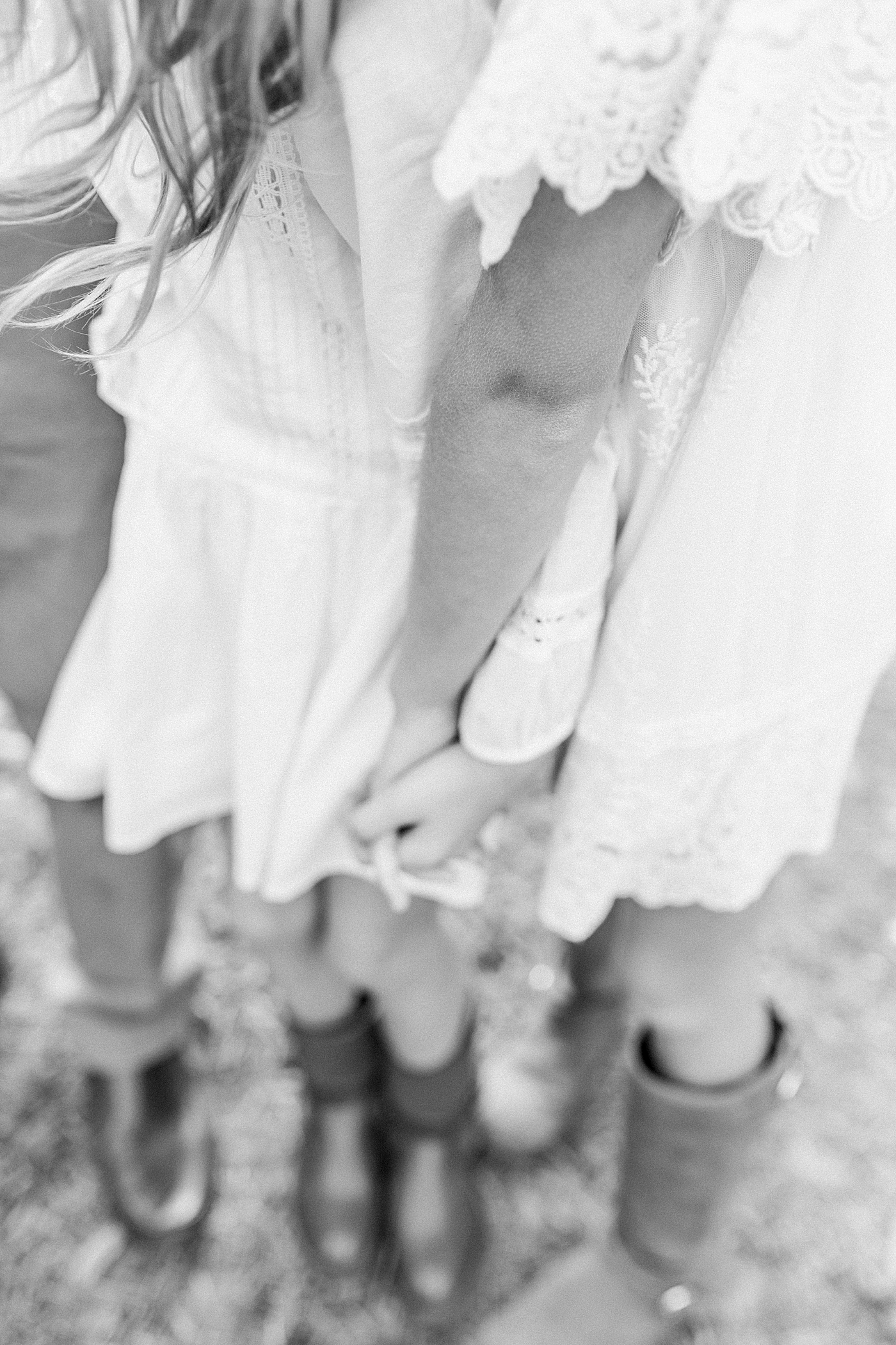 Black and white image of sisters holding hands | Photo by Caitlyn Motycka Photography