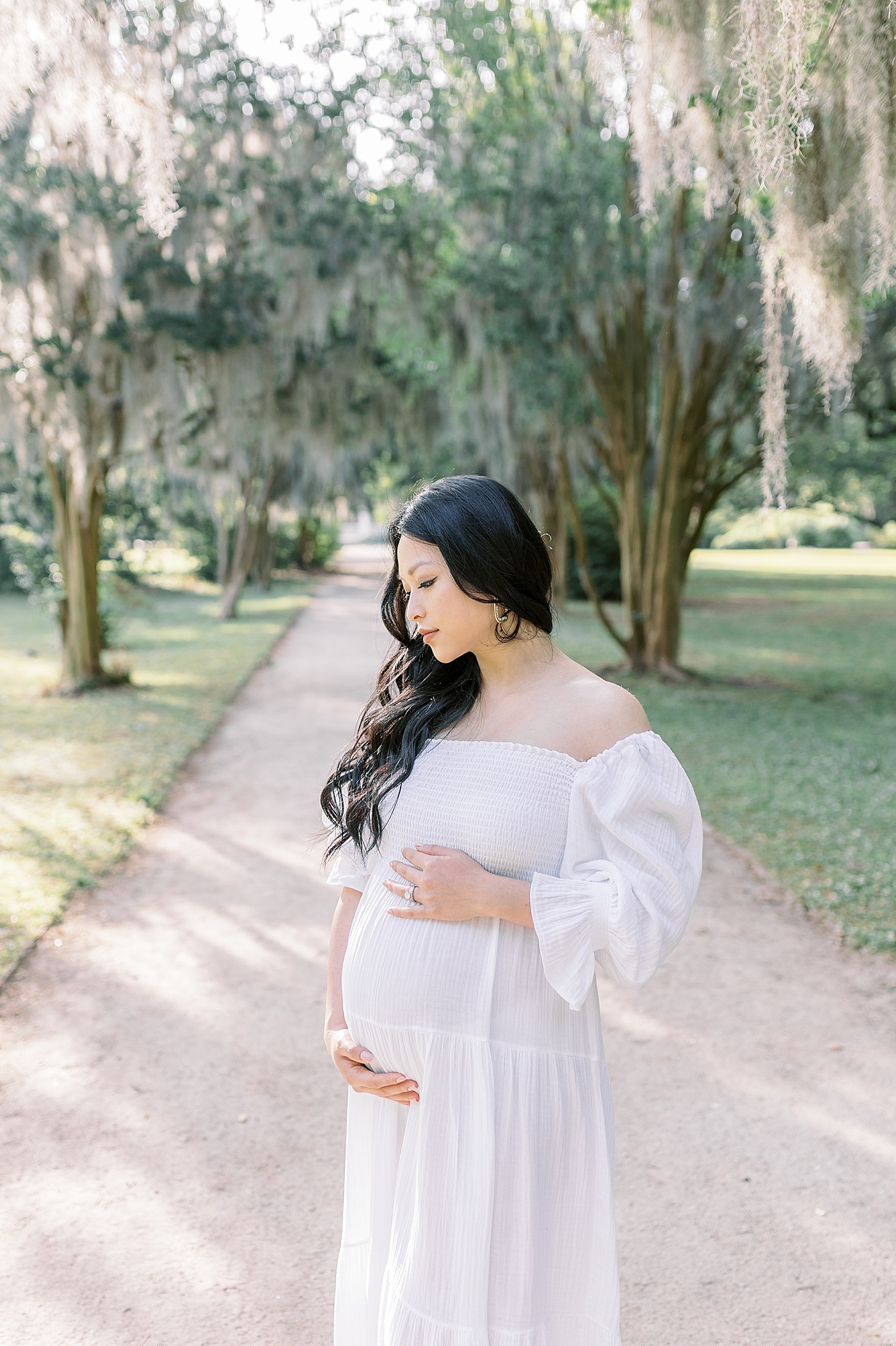 Mother to be cradling her belly | Photo by Caitlyn Motycka Photography