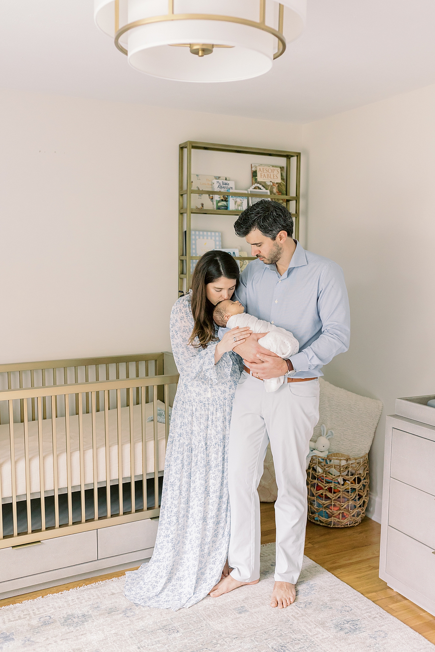 Mom and dad snuggling their new baby | Photo by Mount Pleasant Newborn Photographer Caitlyn Motycka
