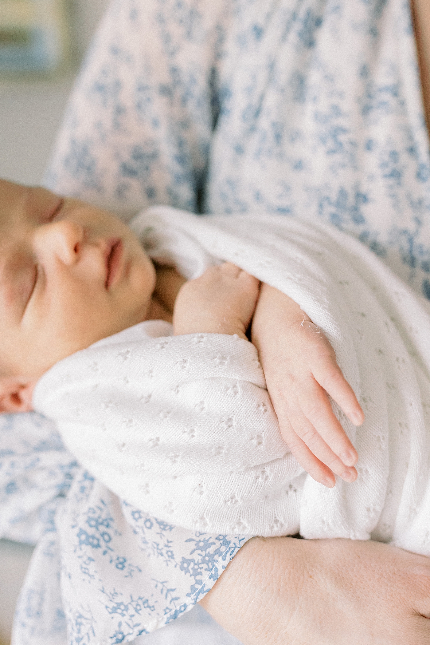 Newborn wrapped in a white swaddle | Photo by Mount Pleasant Newborn Photographer Caitlyn Motycka