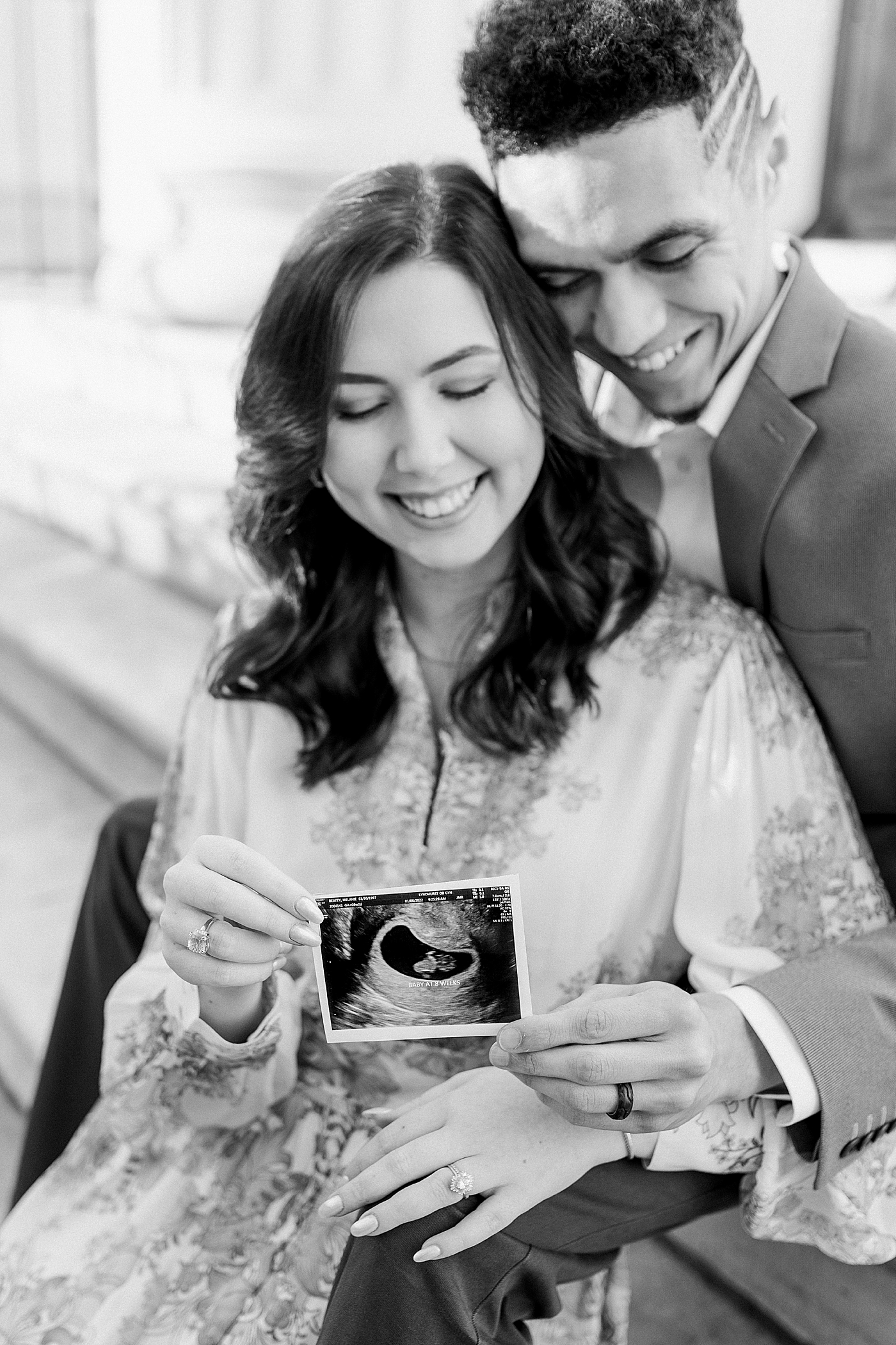 Black and white image of parents holding sonogram during their Pregnancy Announcement in Downtown Charleston | Photo by Caitlyn Motycka Photography