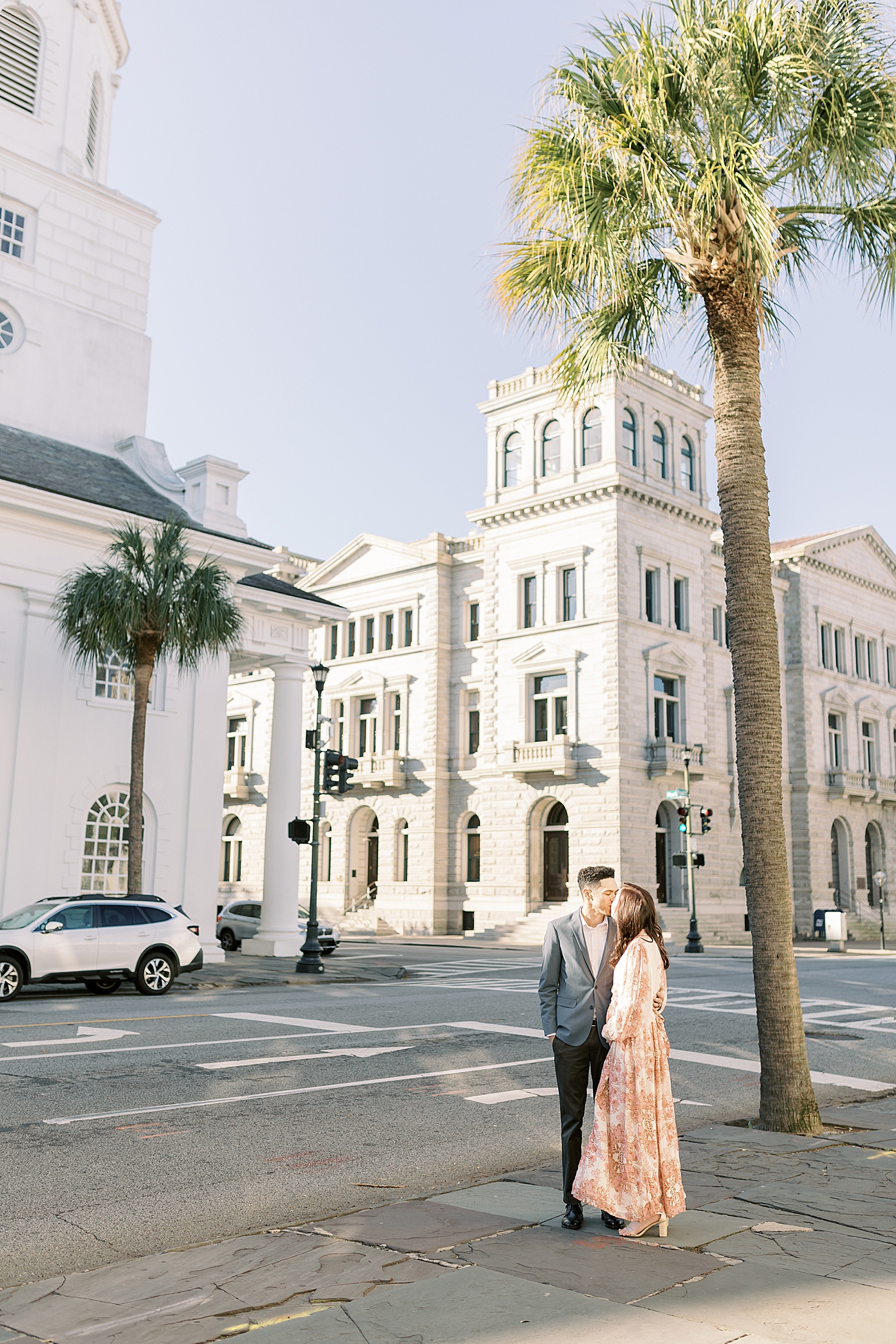 Couple kissing during their Pregnancy Announcement in Downtown Charleston | Photo by Caitlyn Motycka Photography