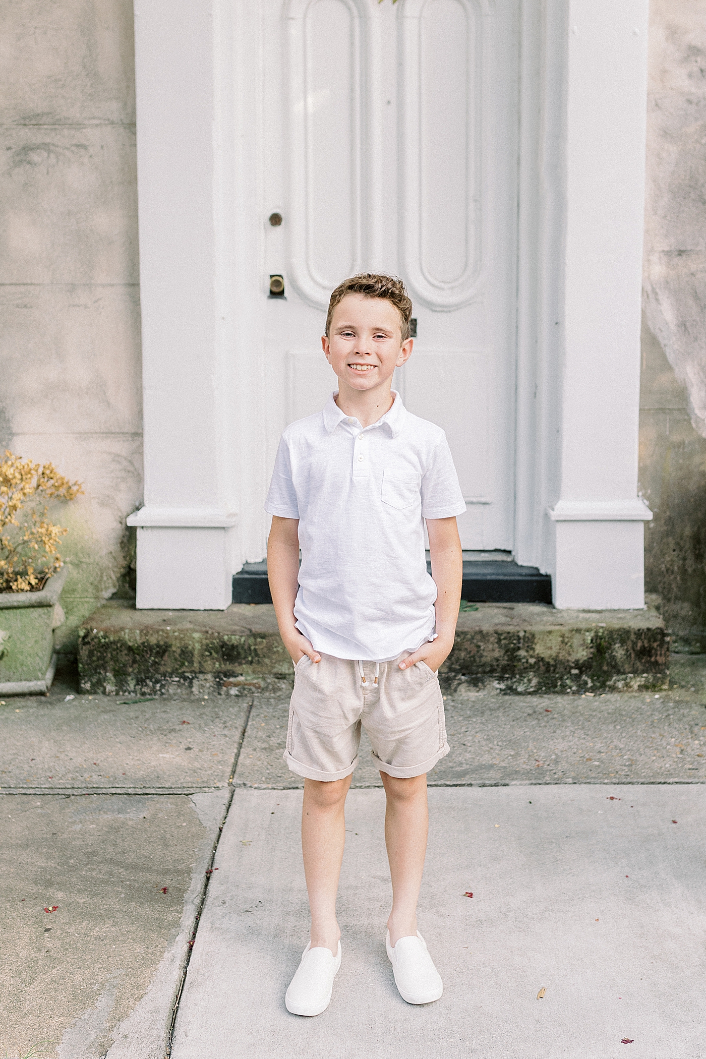 Little boy in a white shirt with his hands in his pockets | Photo by Caitlyn Motycka Photography