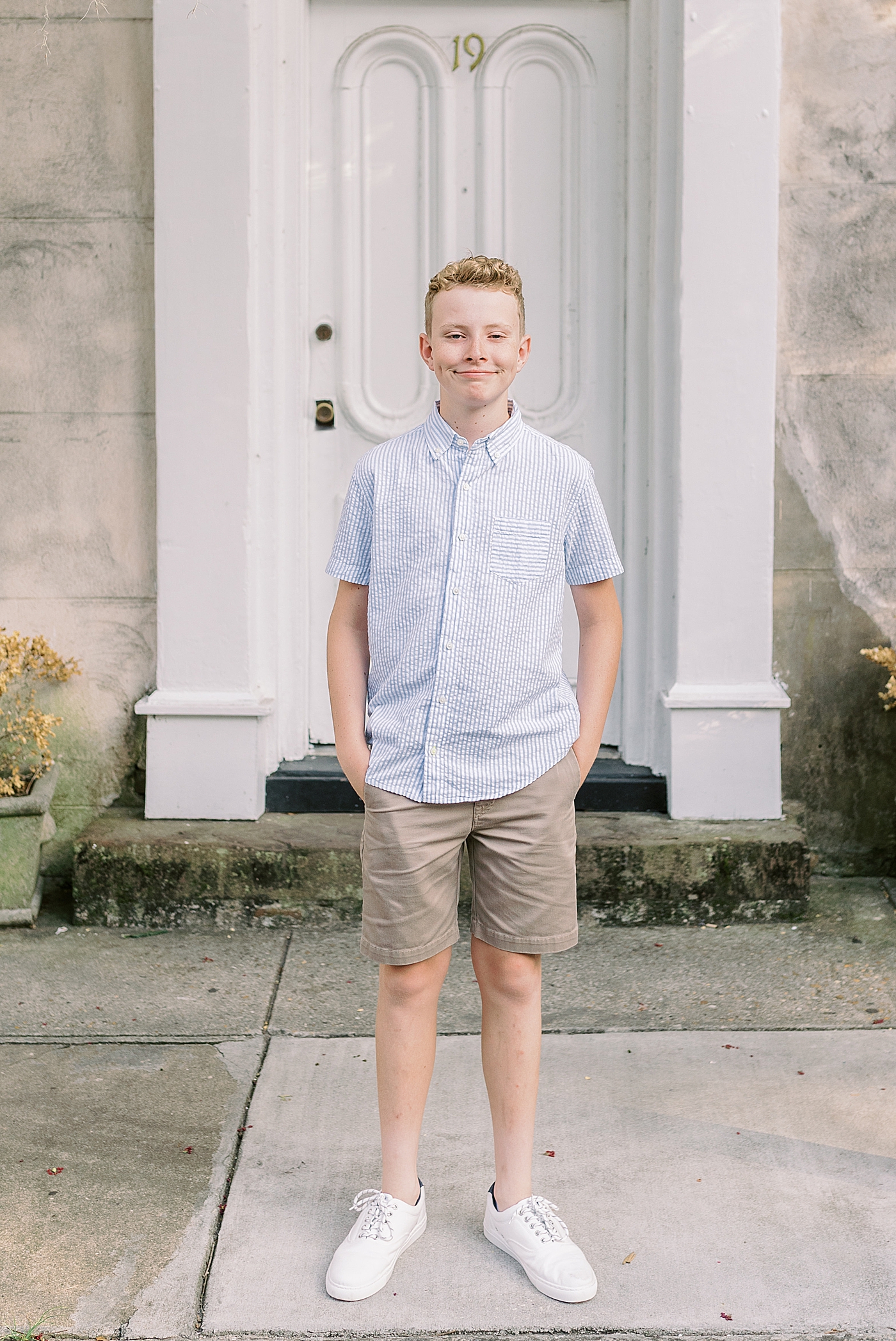 Boy in a striped shirt and khaki shorts | Photo by Caitlyn Motycka Photography