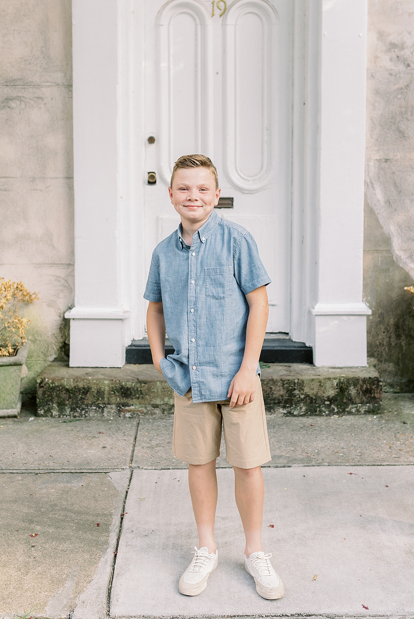 Little boy in a blue shirt with his hand in his pocket | Photo by Caitlyn Motycka Photography