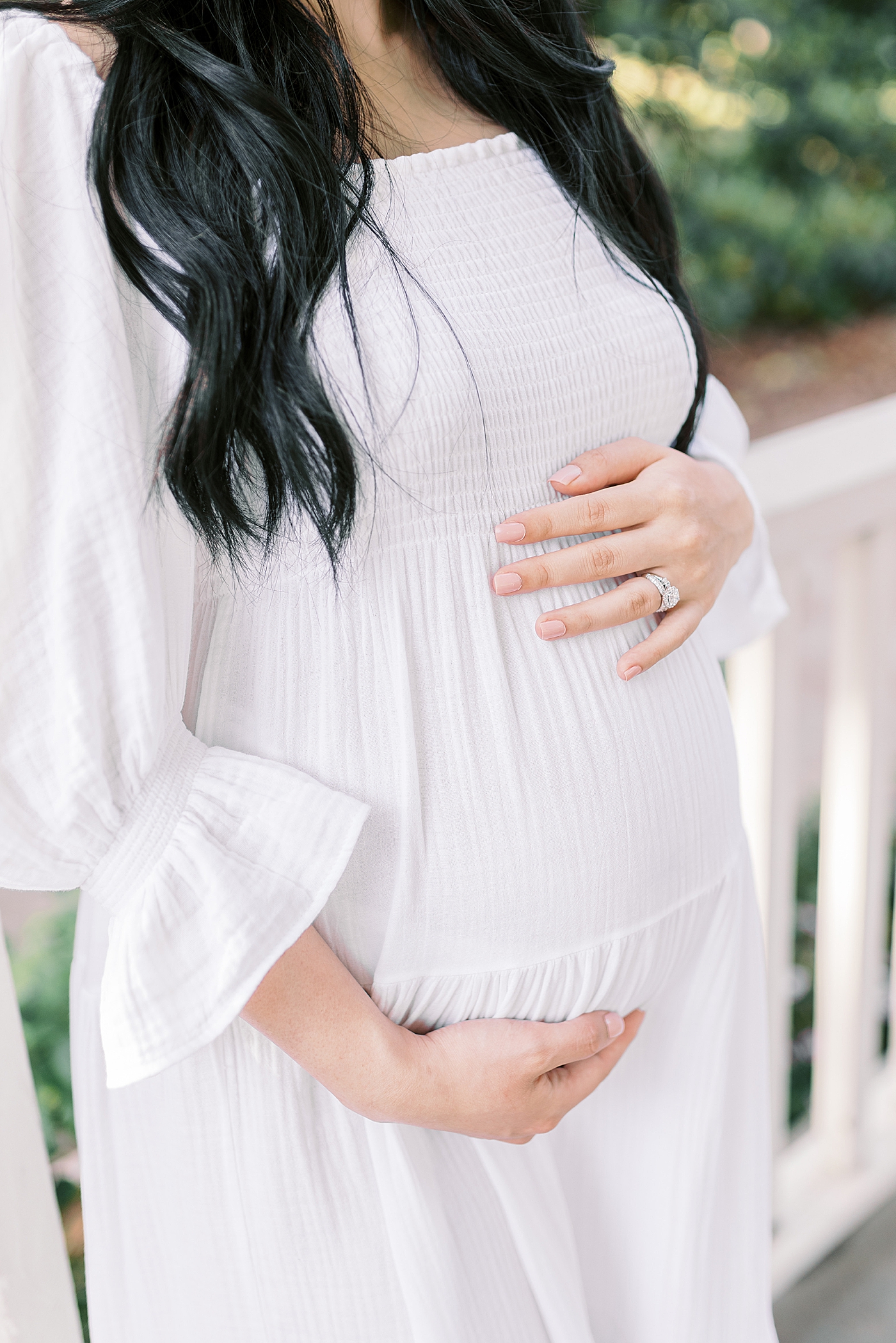 Detail of mother to be holding her belly | Photo by Caitlyn Motycka Photography