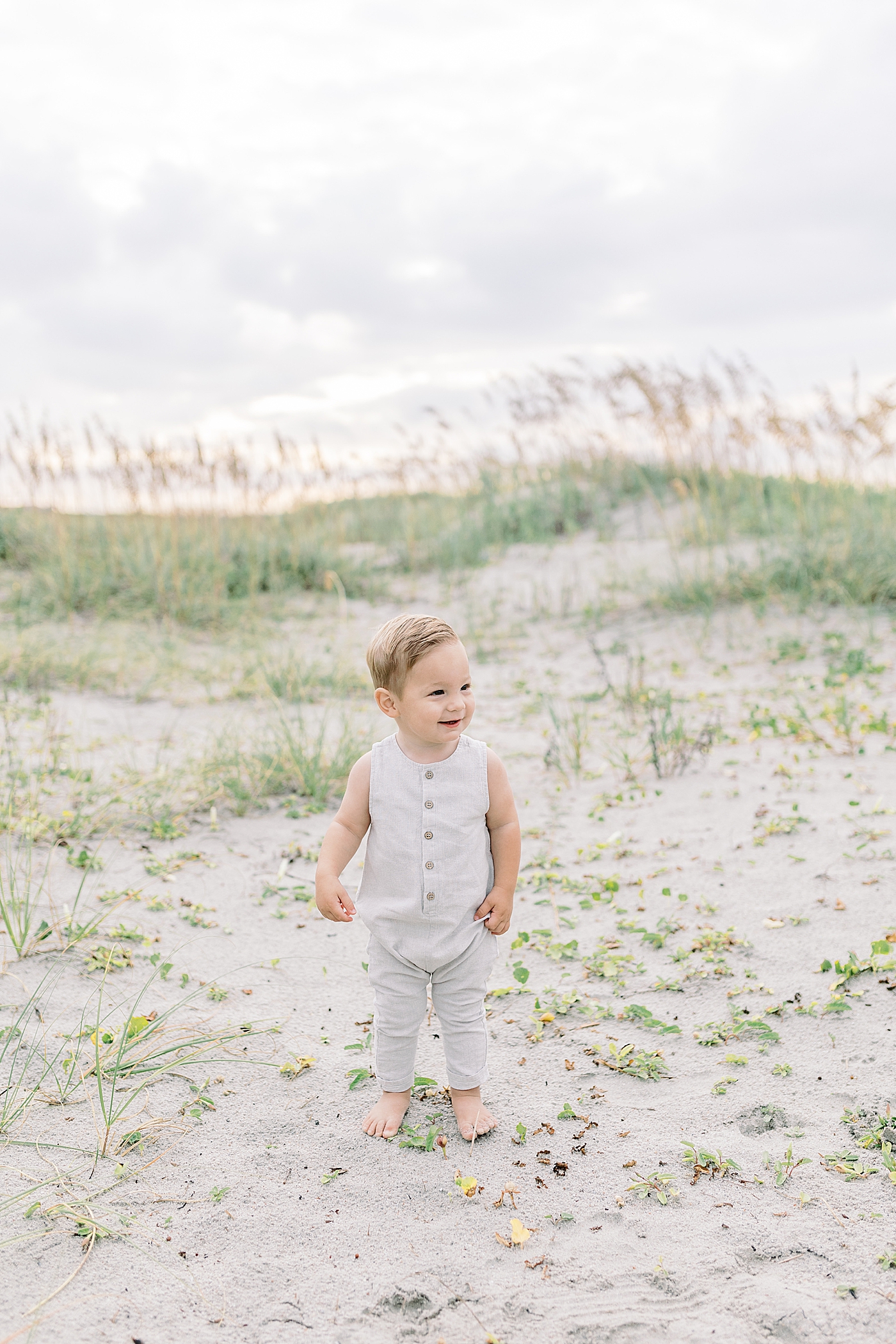 Baby boy walking near sand dunes | Preparing for Family Beach Session with Caitlyn Motycka