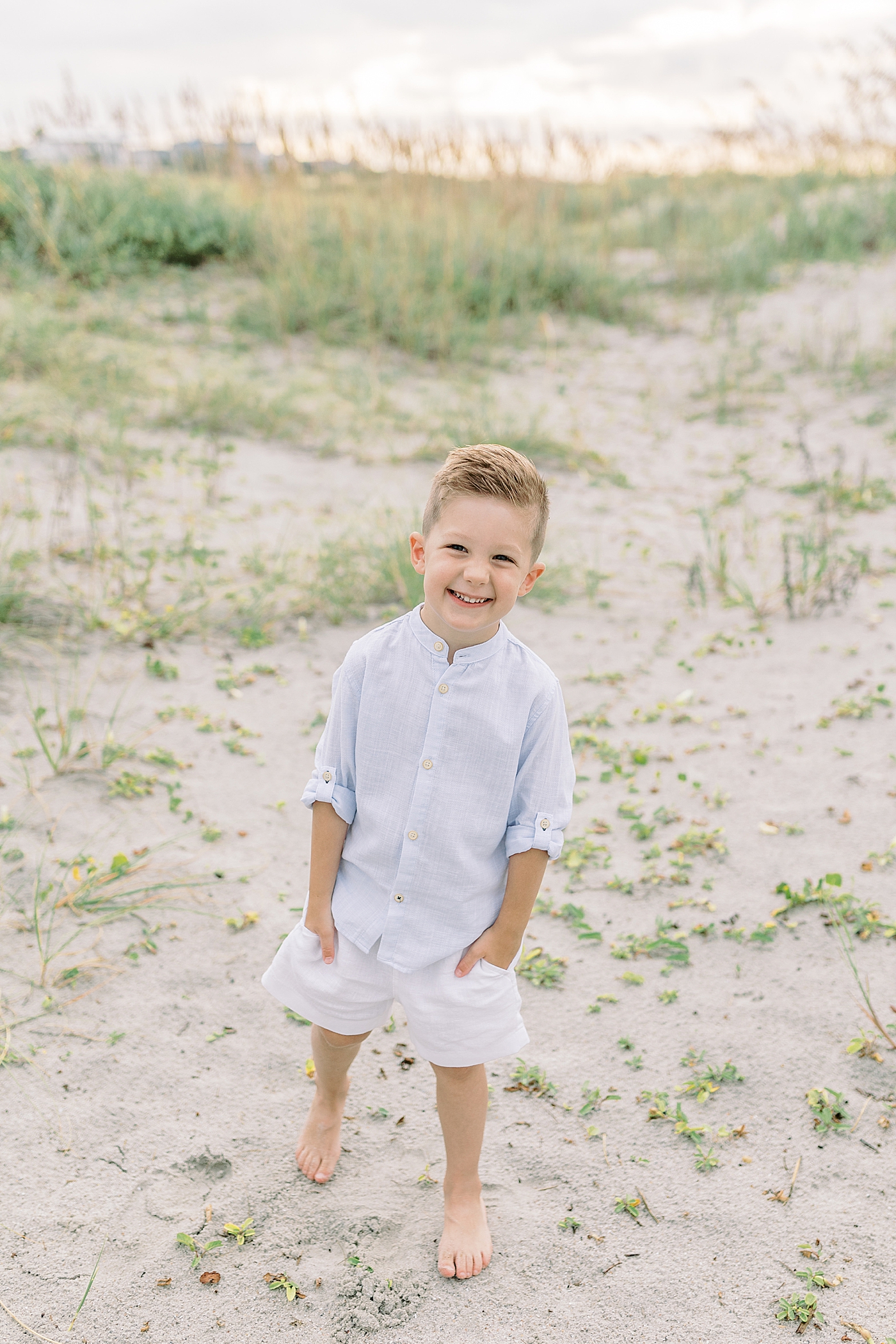 Little boy smiling with his hands in his pocket | Preparing for Family Beach Session with Caitlyn Motycka