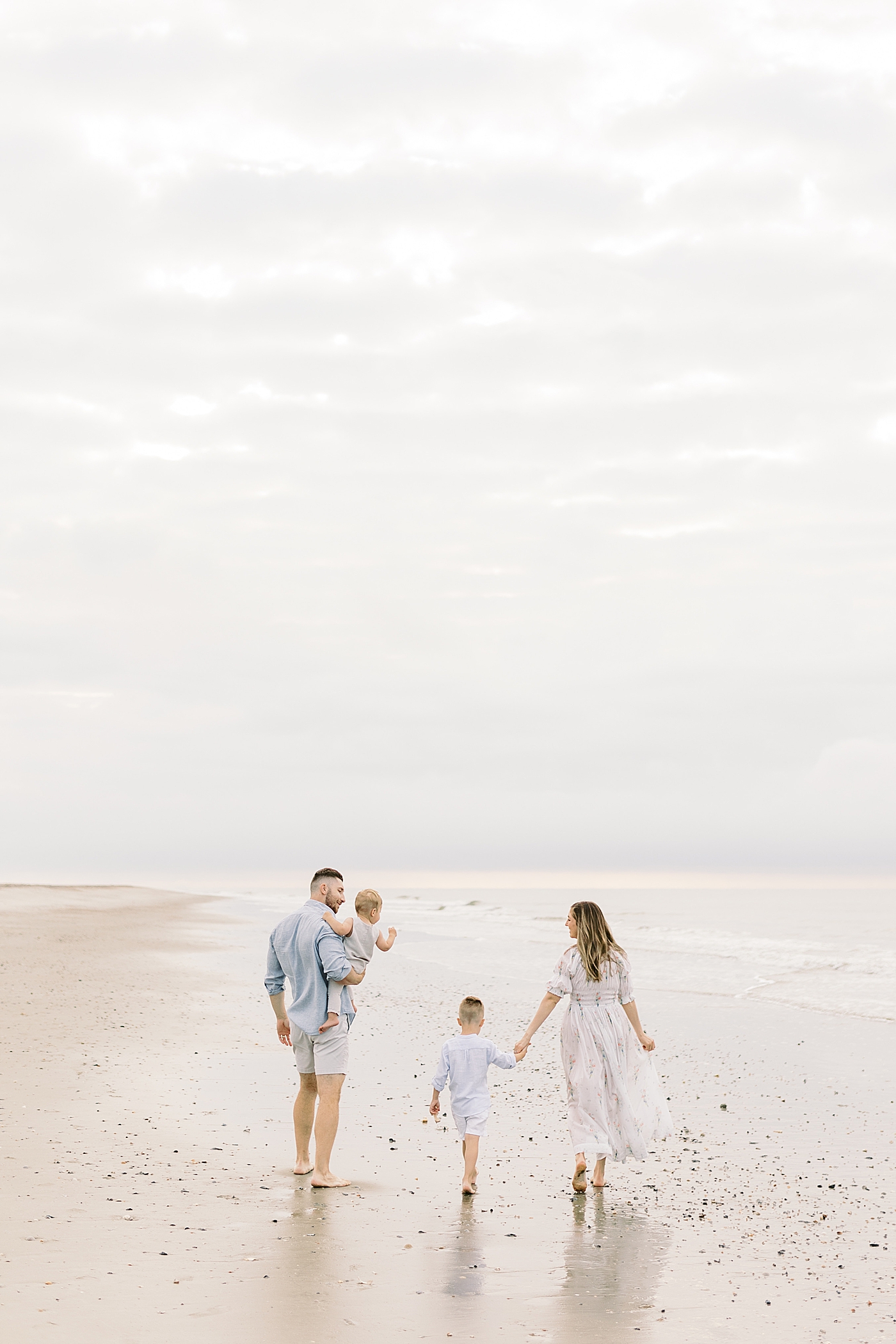 Family walking together on the beach | Image by Caitlyn Motycka