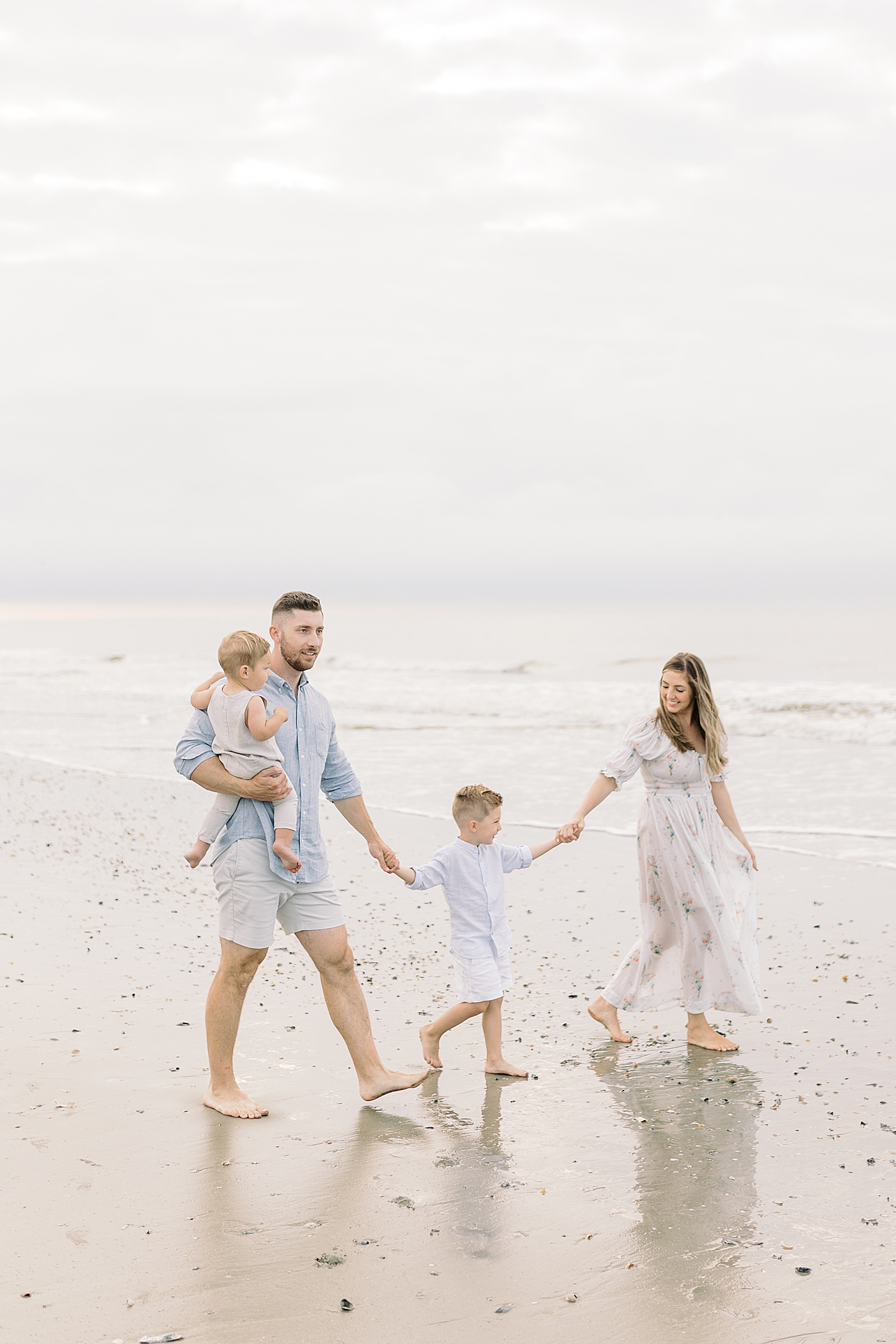 Family walking on the beach | Preparing for Family Beach Session with Caitlyn Motycka