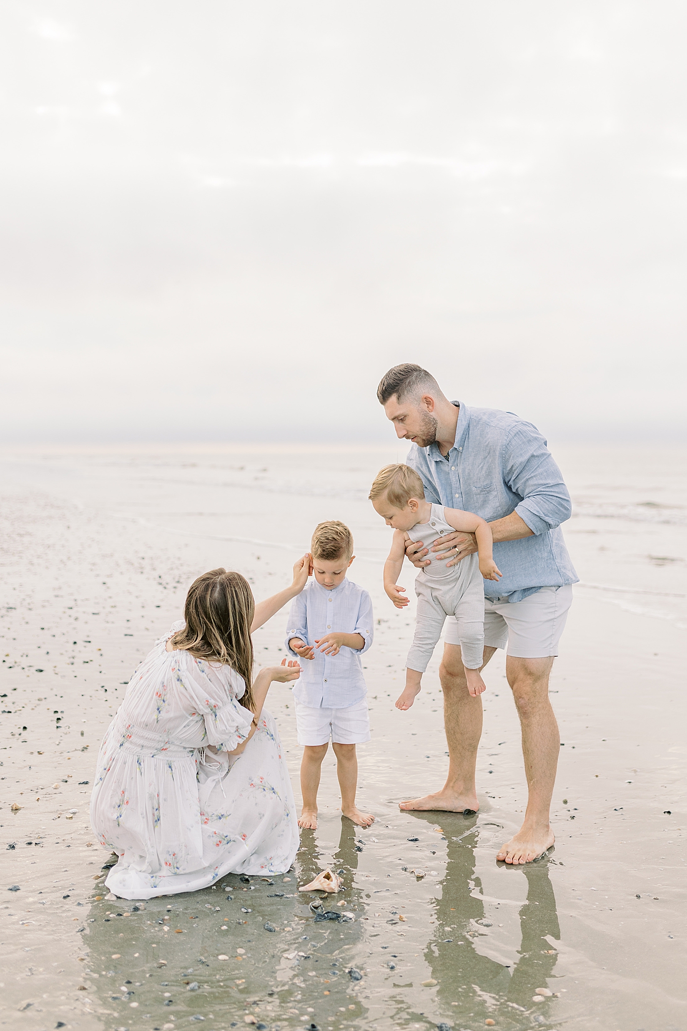 Family searching for seas shells | Preparing for Family Beach Session with Caitlyn Motycka