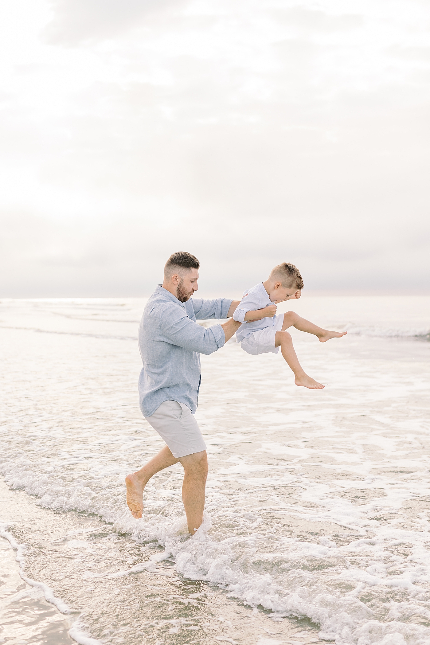 Dad playing with his little boy in the ocean | Preparing for Family Beach Session with Caitlyn Motycka
