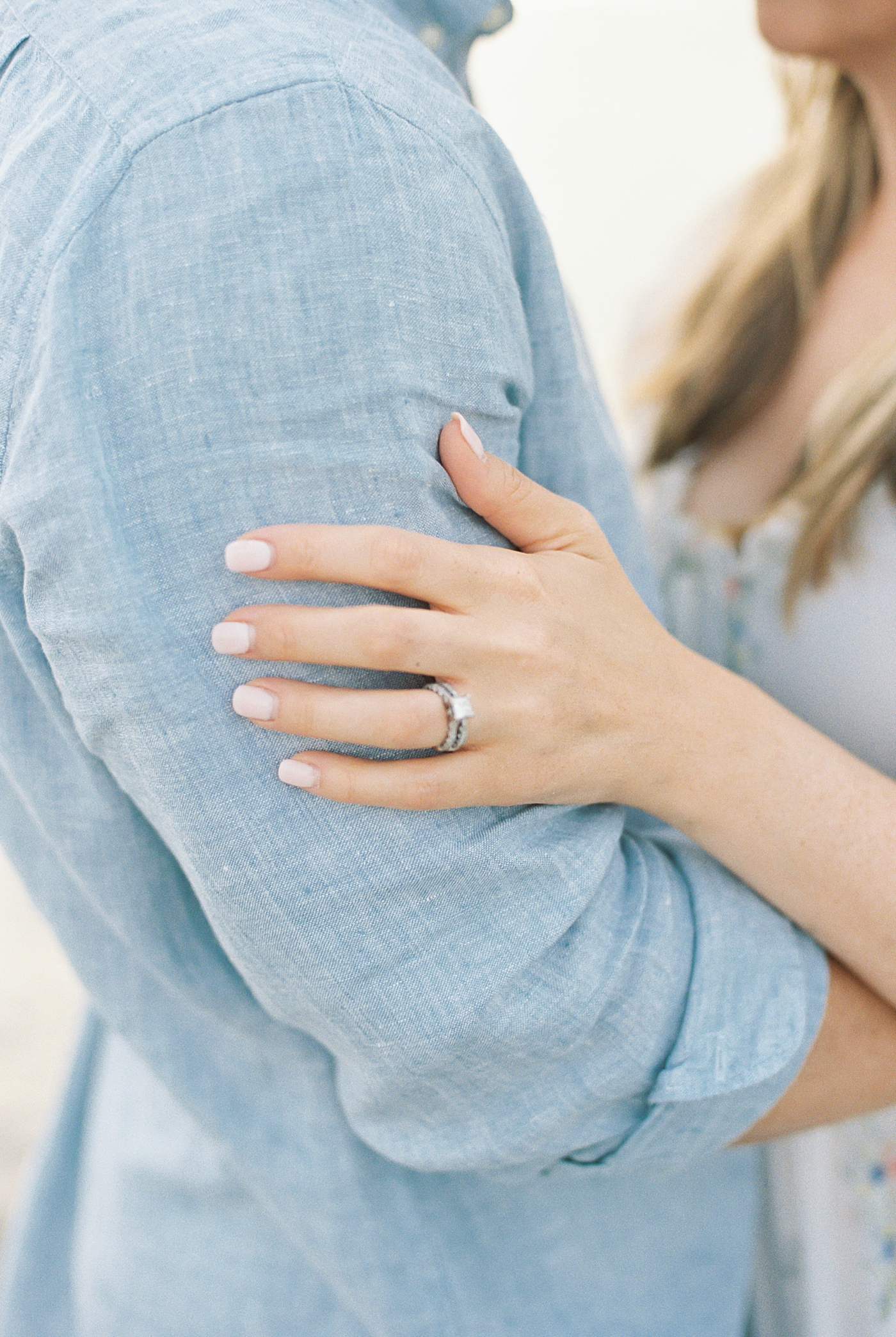 Detail of woman's hand on man's arm | Image by Caitlyn Motycka