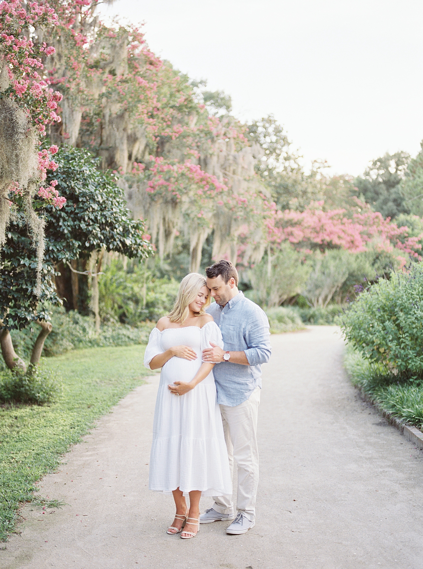 Mom and dad to be snuggling in the park | Dad's Wardrobe Fall Sessions with Caitlyn Motycka Photography