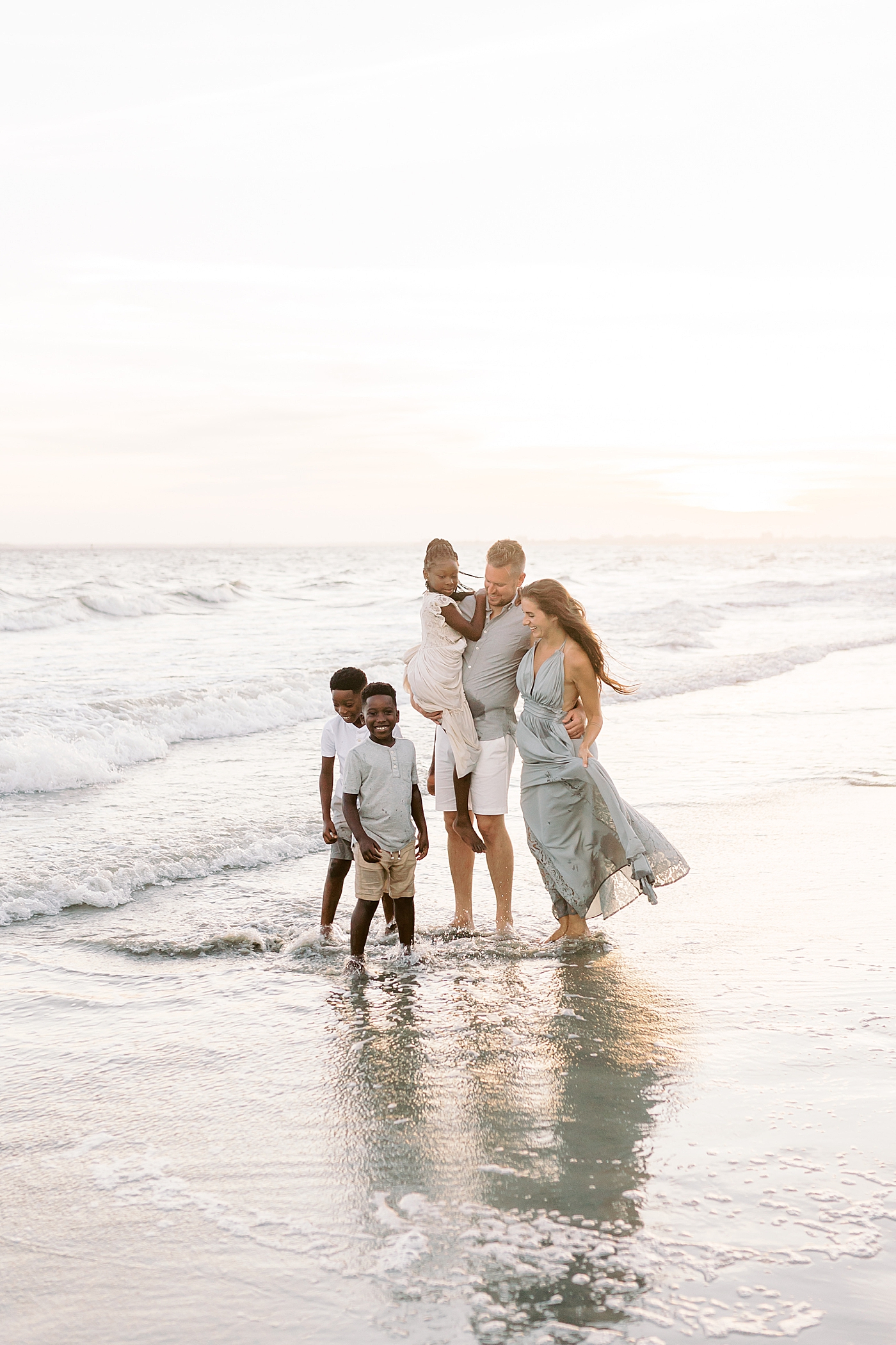 Family interacting during beach family photos in Charleston | Image by Caitlyn Motycka