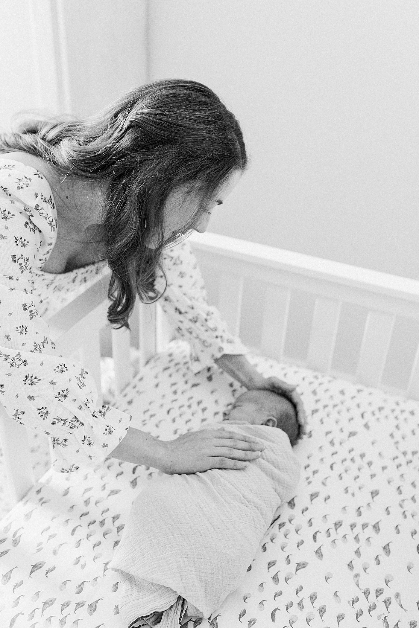 Black and white image of mom putting her baby to sleep | Image by Caitlyn Motycka