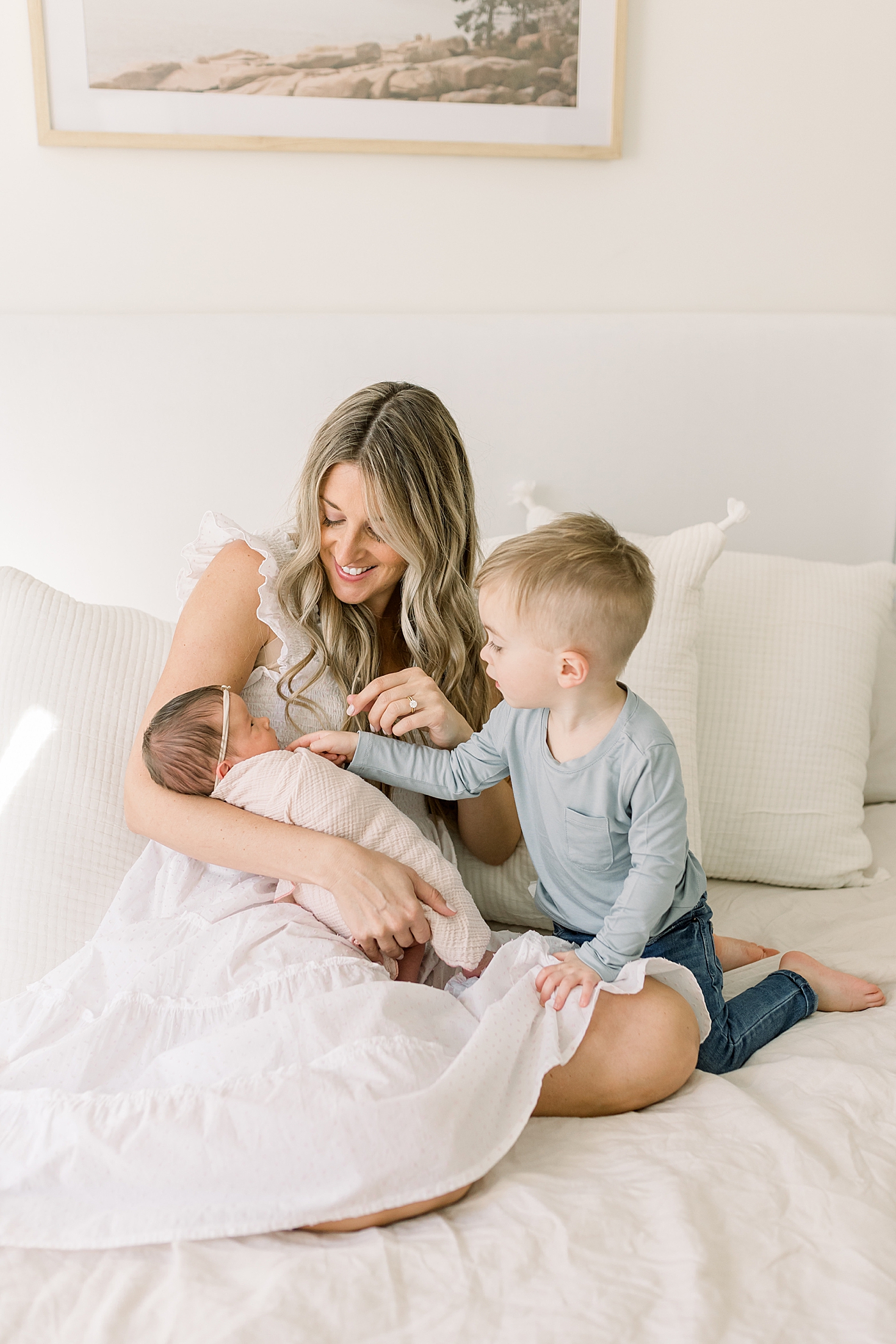 Mom holding newborn and toddler baby boy | Newborn Photos with Toddler with Caitlyn Motycka Photography