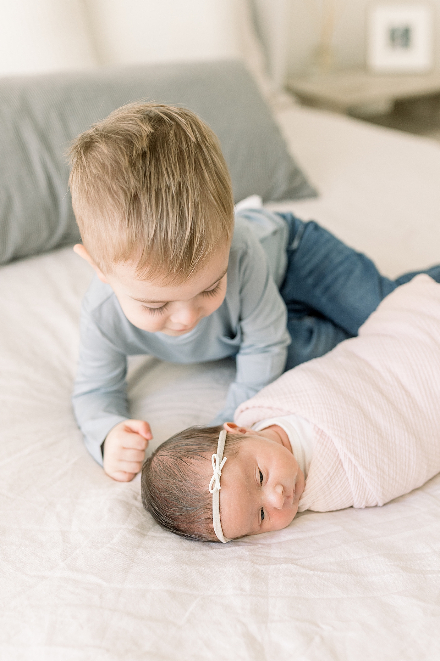 Toddler baby boy interacting with his newborn baby sister | Newborn Photos with Toddler with Caitlyn Motycka Photography