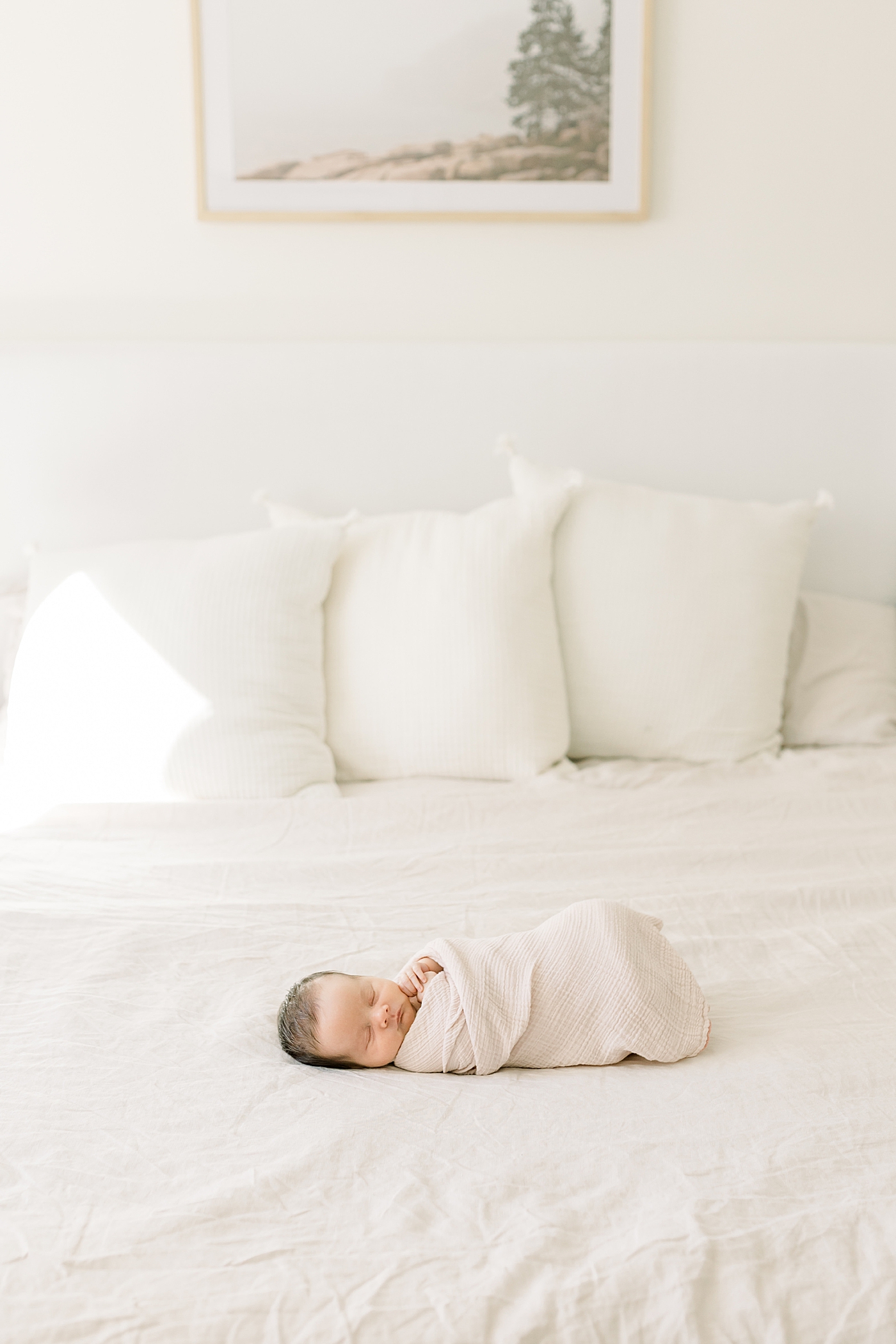 Newborn baby girl wrapped in a cream blanket | Image by Caitlyn Motycka