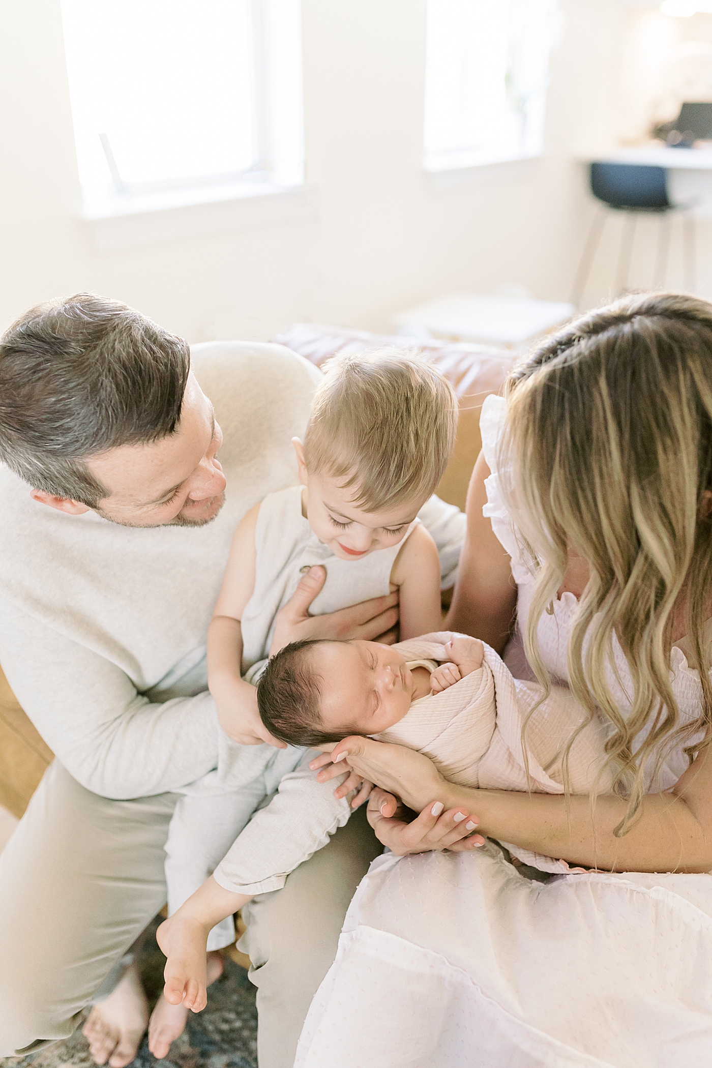 Mom, dad, and toddler holding their newborn baby | Newborn Photos with Toddler with Caitlyn Motycka Photography
