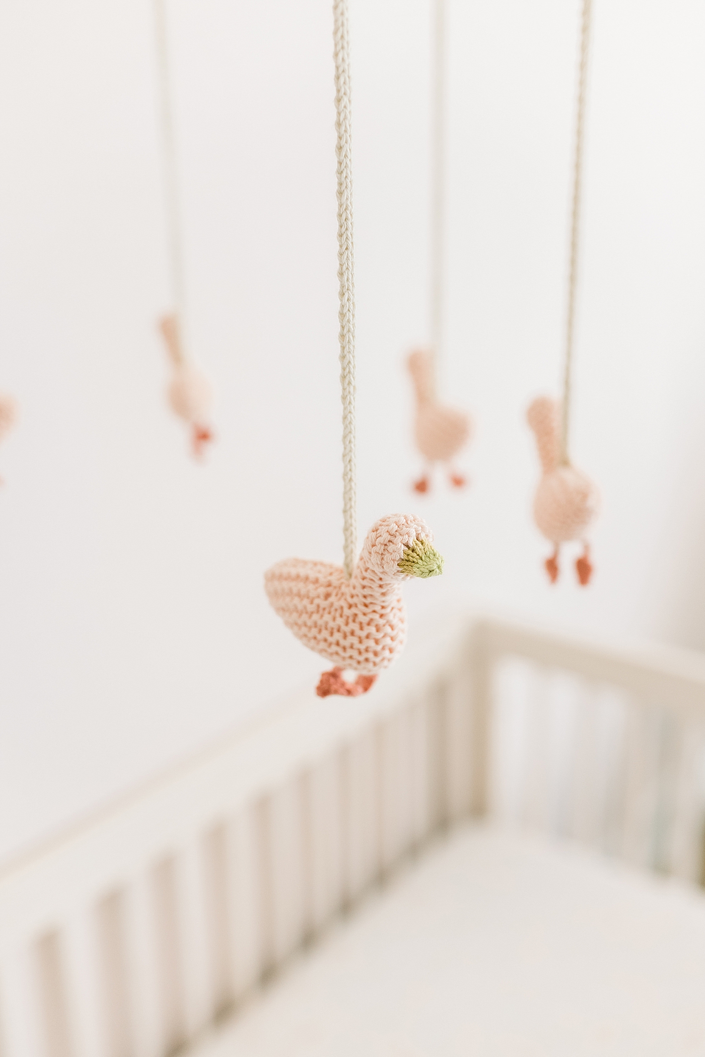 Detail of pink crochet goose mobile in baby nursry | Image by Caitlyn Motycka