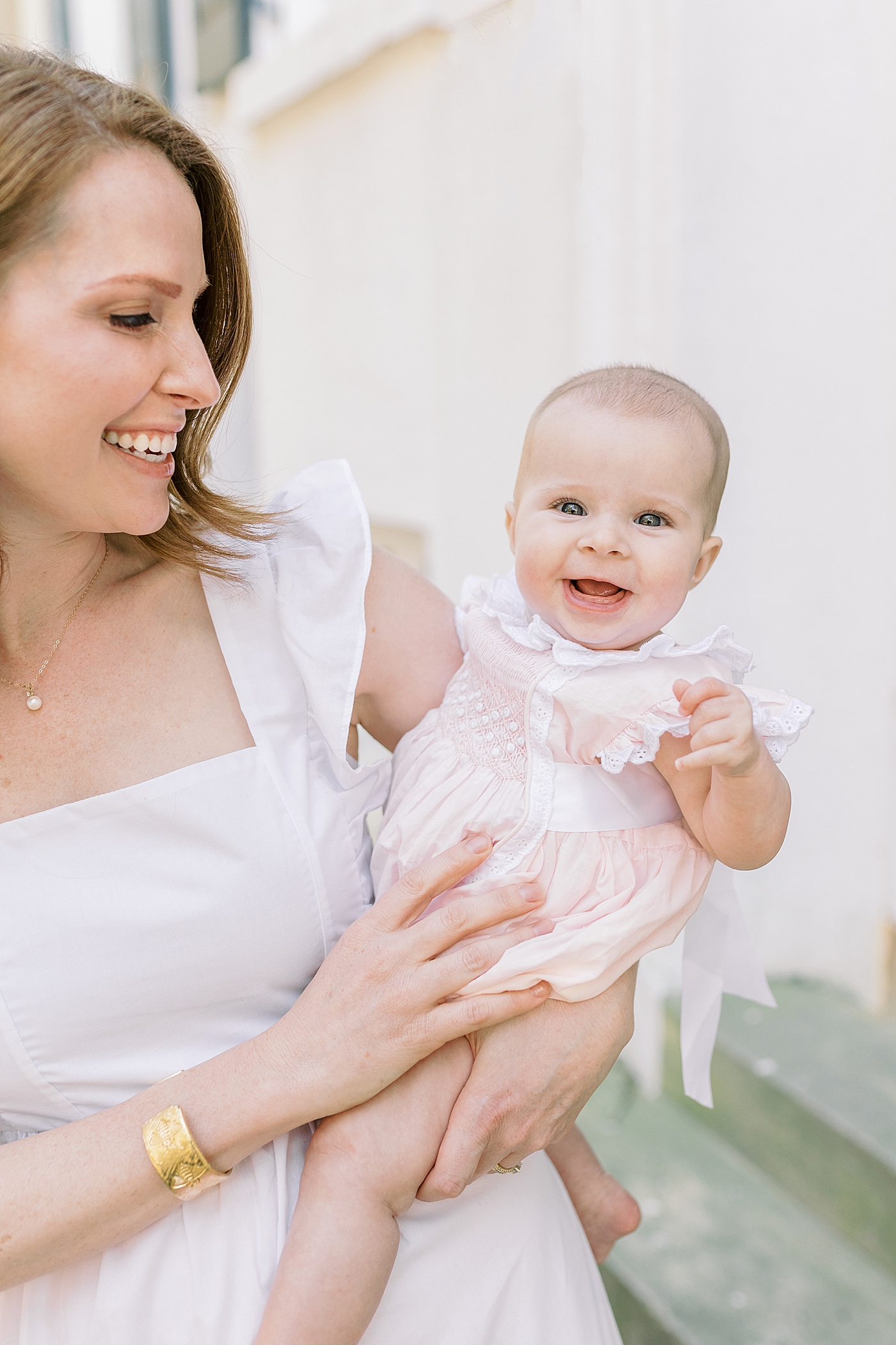 Mother in a spring dress holding her baby | Image by Caitlyn Motycka