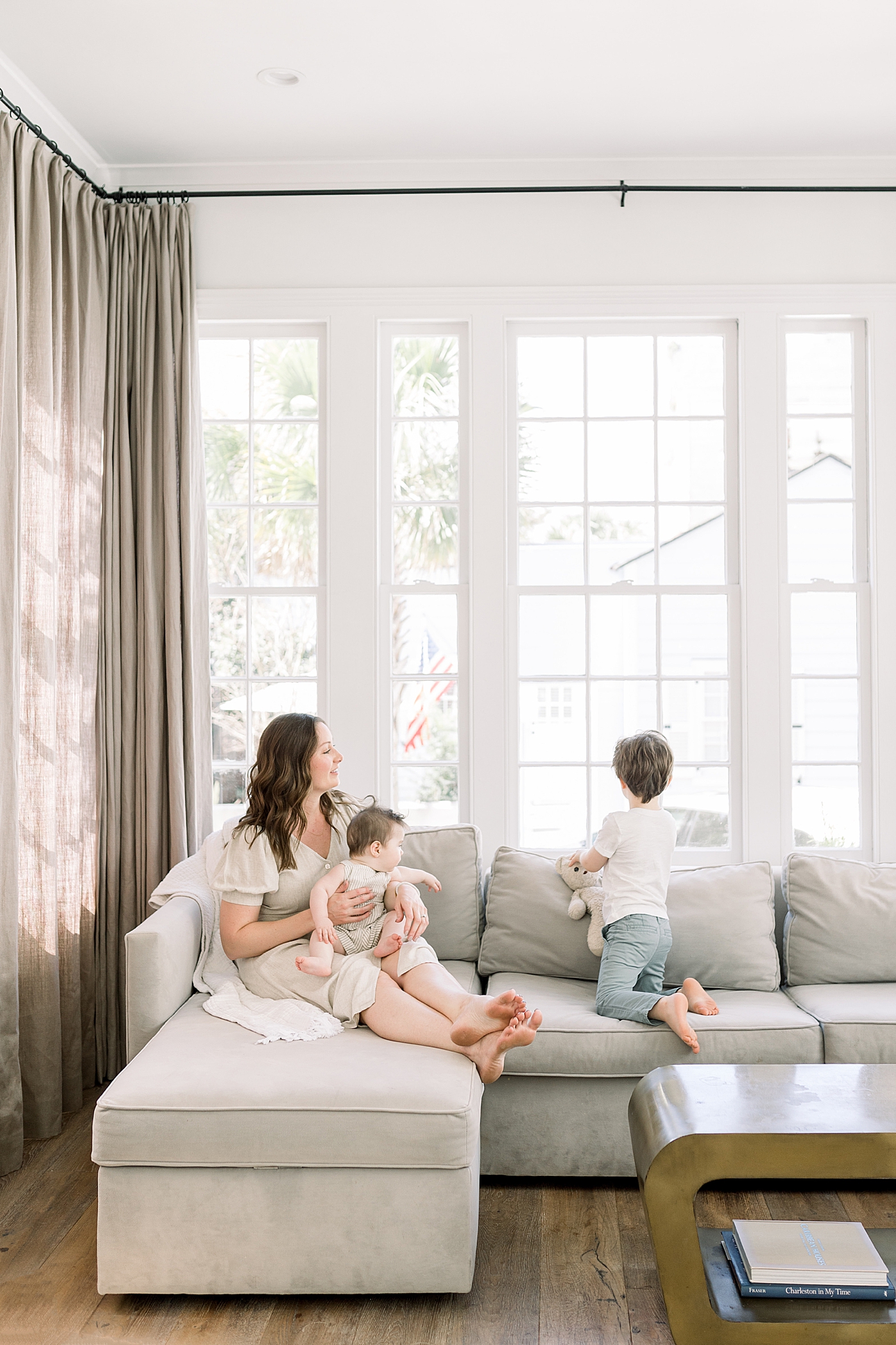 Mother and her two children on a neutral sofa in a clean, neutral room | Image by Caitlyn Motycka 